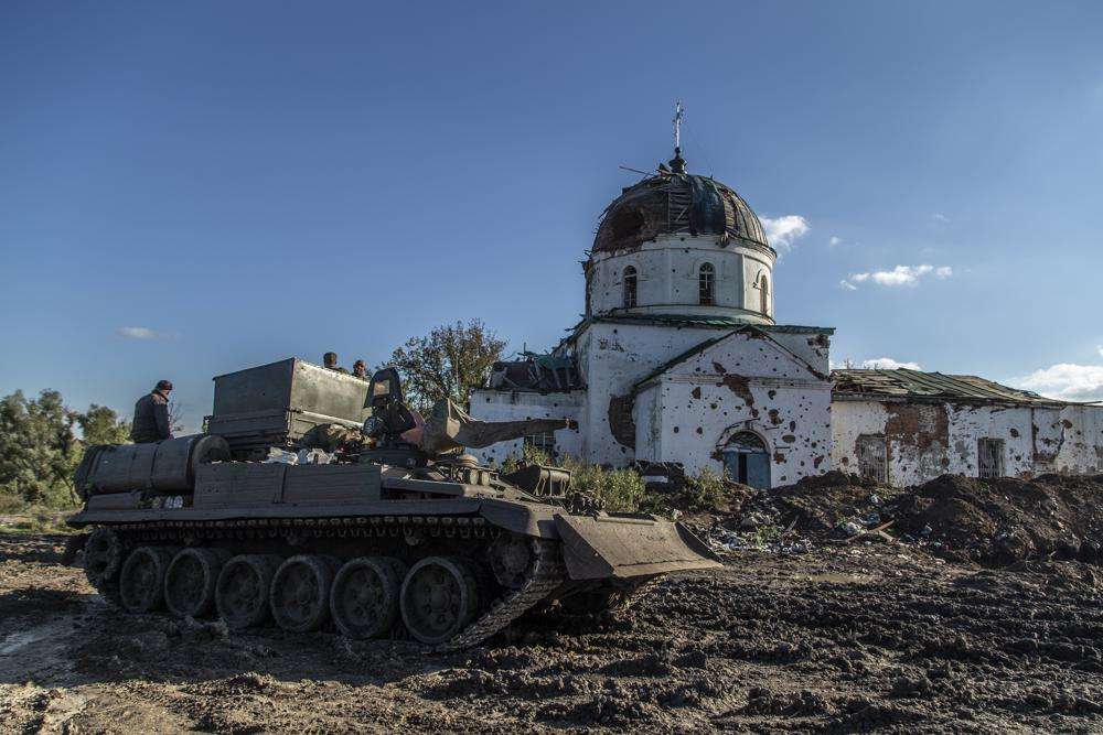 Ukrainian soldiers inspect an abandoned Russian tank in the recently retaken area close to Izium, Ukraine, Wednesday.