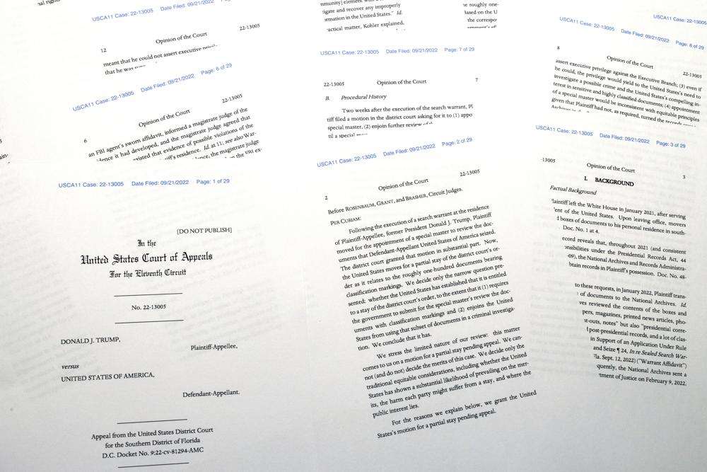Pages from a U.S. Court of Appeals for the 11th Circuit in Atlanta ruling that lifts a judge's hold on the Justice Department's ability to use classified documents seized by the FBI at Trump's Mar-a-Lago estate, are photographed Wednesday. The ruling clears the way for the department to immediately resume its use of the documents in its investigation.