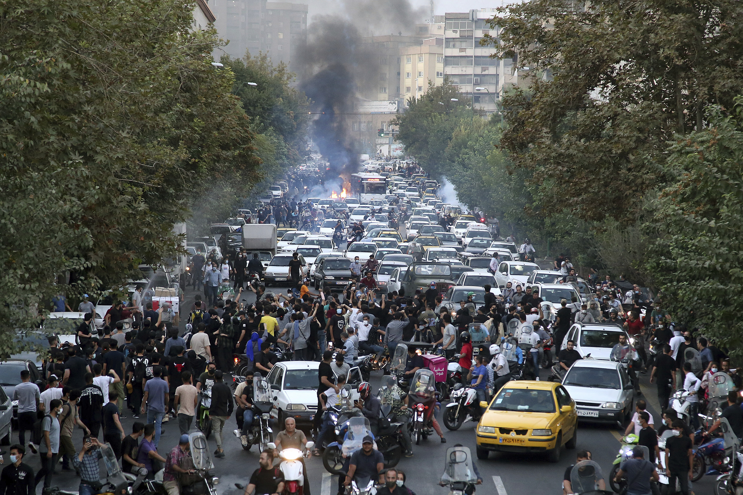 Protesters chant slogans during a protest over the death of a woman who was detained by the morality police, in downtown Tehran, Iran, on Wednesday.