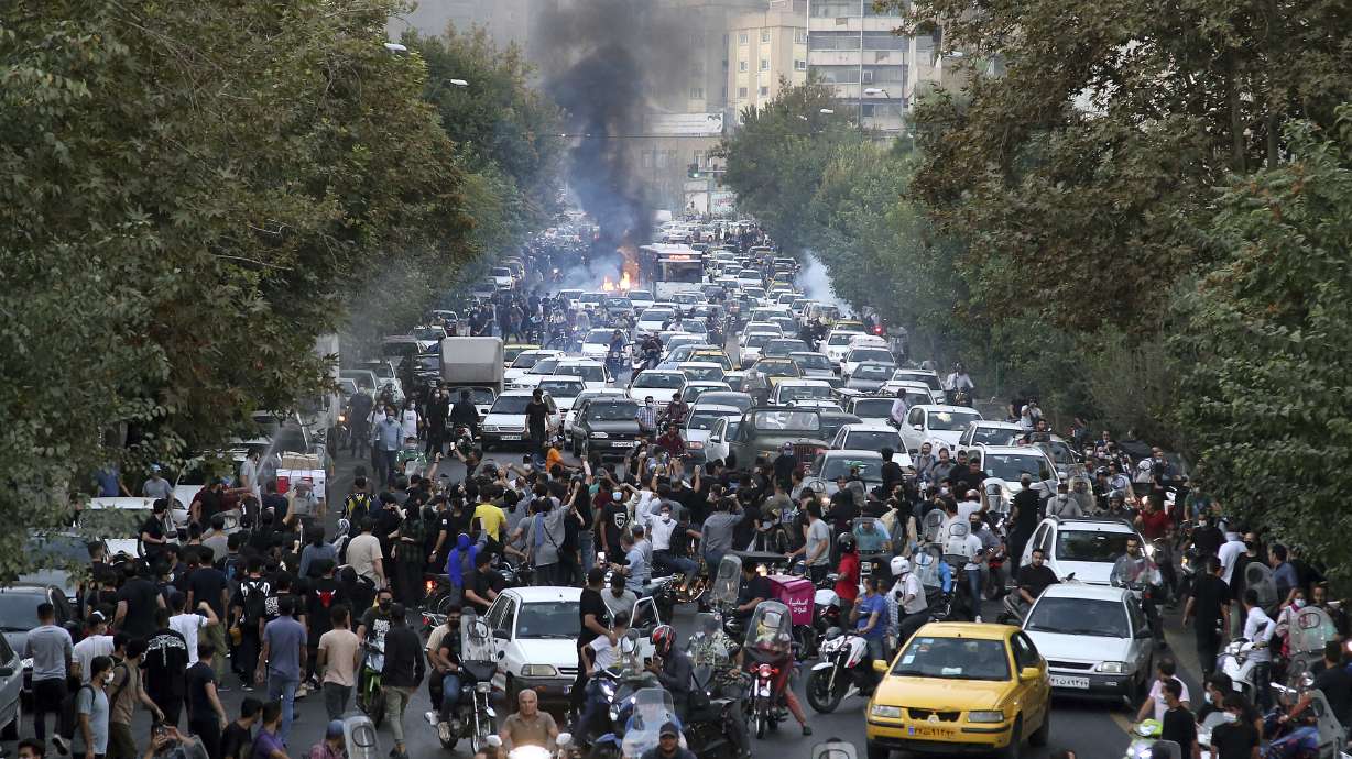 Protesters chant slogans during a protest over the death of a woman who was detained by the morality police, in downtown Tehran, Iran, on Wednesday.