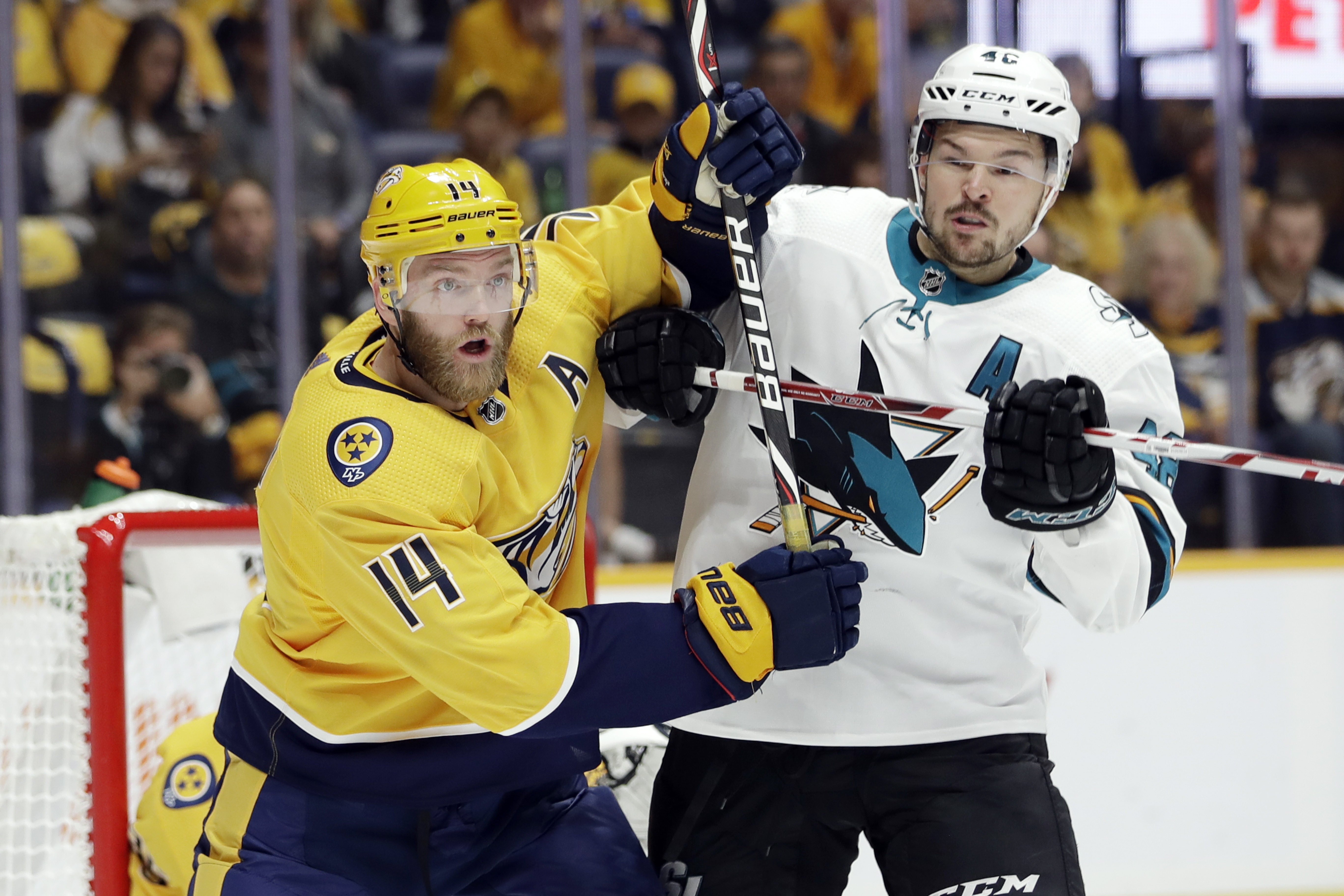 FILE - Nashville Predators defenseman Mattias Ekholm (14), of Sweden, and San Jose Sharks center Tomas Hertl (48), of the Czech Republic, battle in the first period of an NHL hockey game Tuesday, Oct. 8, 2019, in Nashville, Tenn. The forthcoming NHL regular season’s games between the Nashville Predators and San Jose Sharks in Prague face an obstacle. The Czech Foreign Ministry has been opposing the participation of the Russian players from those teams in the Oct. 7 and 8 games at Prague’s O2 Arena due to Russia’s war against Ukraine. 