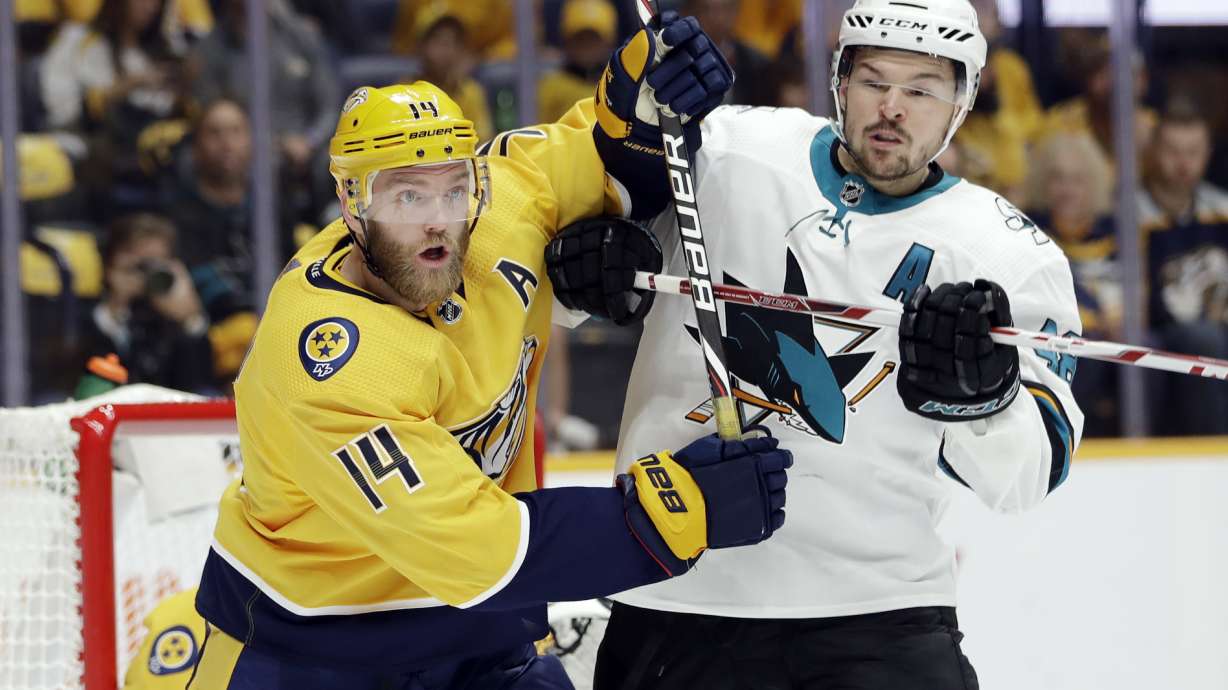 FILE - Nashville Predators defenseman Mattias Ekholm (14), of Sweden, and San Jose Sharks center Tomas Hertl (48), of the Czech Republic, battle in the first period of an NHL hockey game Tuesday, Oct. 8, 2019, in Nashville, Tenn. The forthcoming NHL regular season’s games between the Nashville Predators and San Jose Sharks in Prague face an obstacle. The Czech Foreign Ministry has been opposing the participation of the Russian players from those teams in the Oct. 7 and 8 games at Prague’s O2 Arena due to Russia’s war against Ukraine.