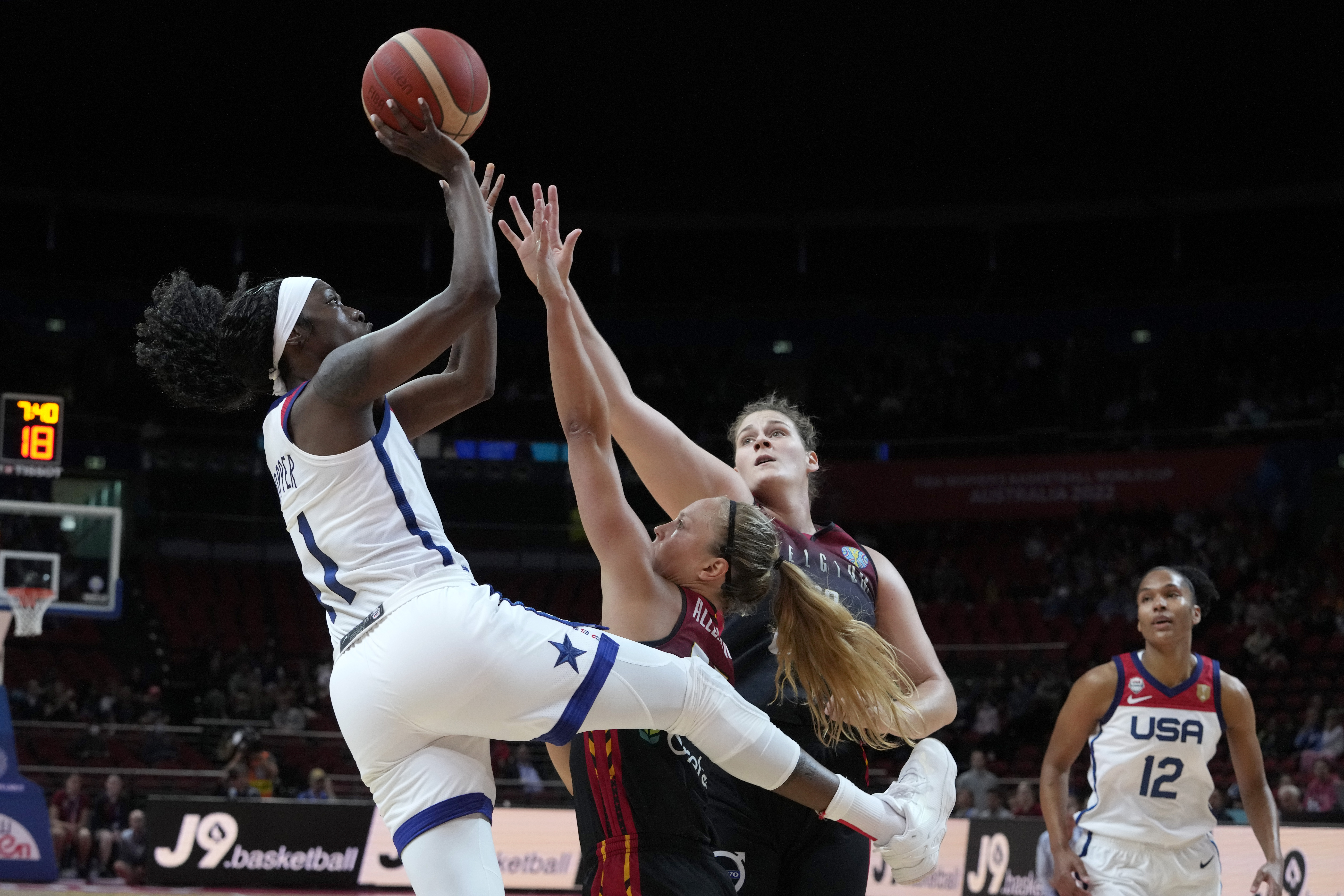 United States' Kahleah Copper, left, shoots over Belgium's Julie Allemand, second left, and Kyara Linskens during their women's Basketball World Cup game in Sydney, Australia, Thursday, Sept. 22, 2022. 