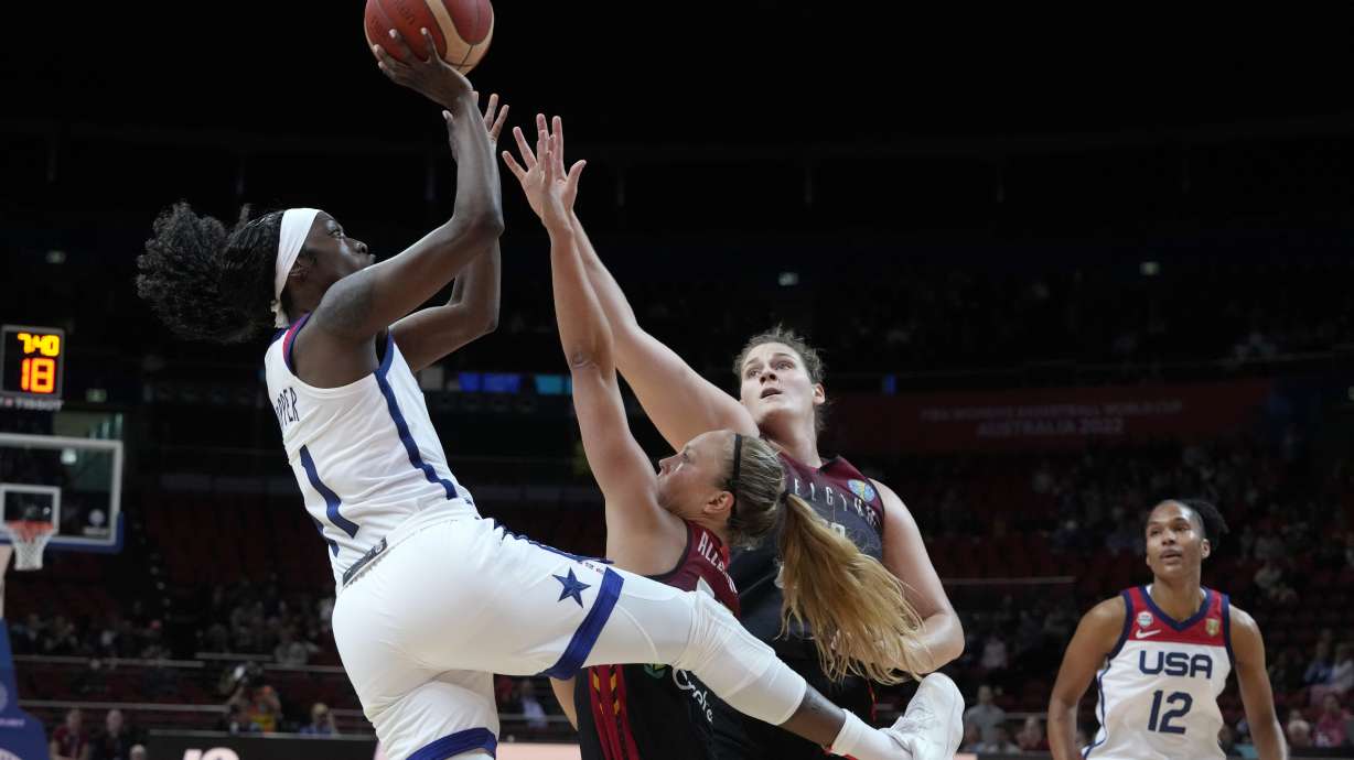 United States' Kahleah Copper, left, shoots over Belgium's Julie Allemand, second left, and Kyara Linskens during their women's Basketball World Cup game in Sydney, Australia, Thursday, Sept. 22, 2022.
