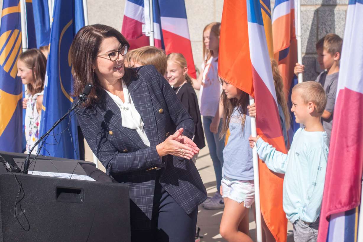 Lt. Gov. Deidre Henderson applauds students from an Ellison Park Elementary School fourth grade class who volunteered to hold Utah's 20 semifinalist flags during a Thursday morning ceremony. The flags will remain on display at the Utah Capitol through Oct. 5.