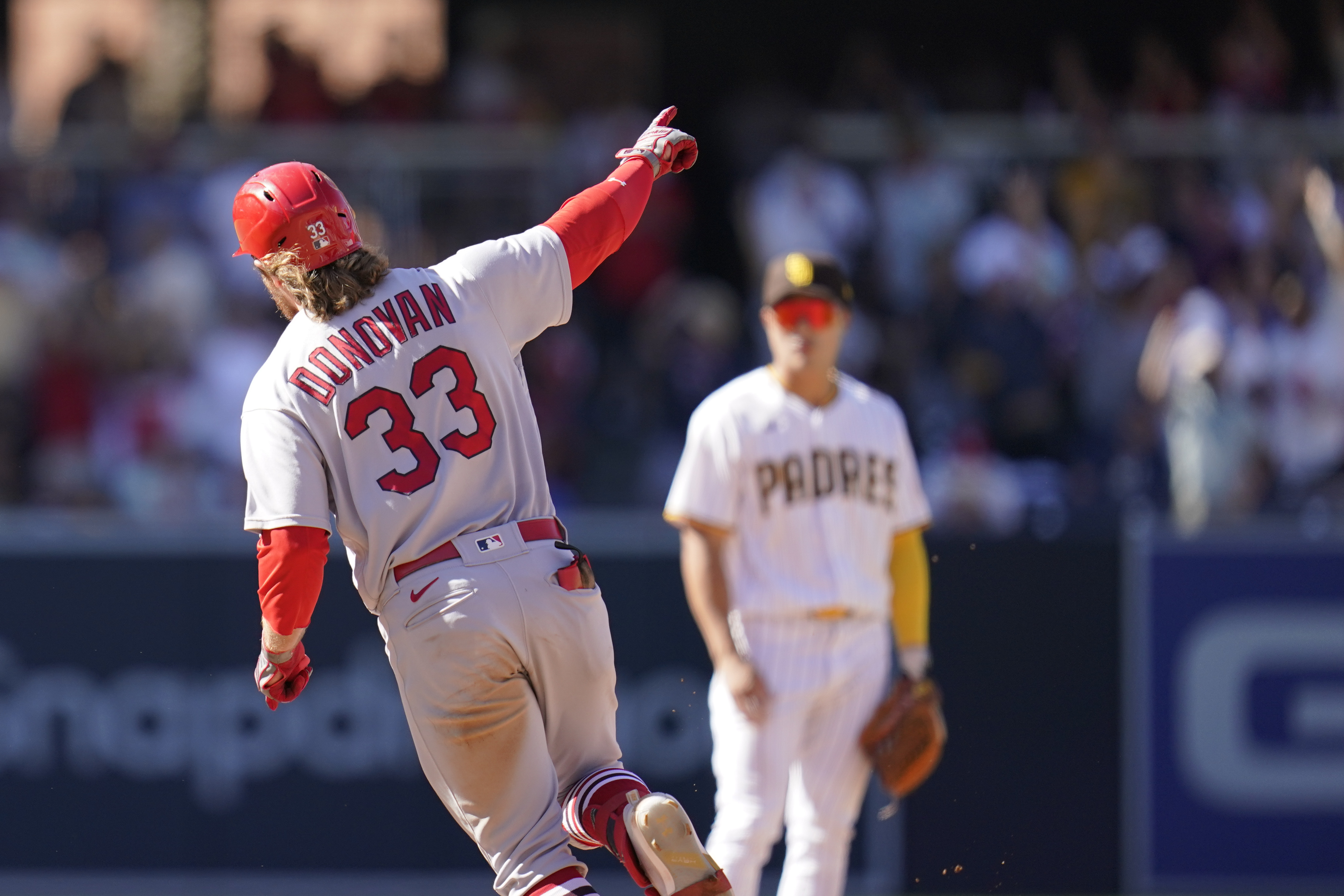St. Louis Cardinals' Brendan Donovan, left, reacts after hitting a grand slam during the seventh inning of a baseball game against the San Diego Padres, Thursday, Sept. 22, 2022, in San Diego. 