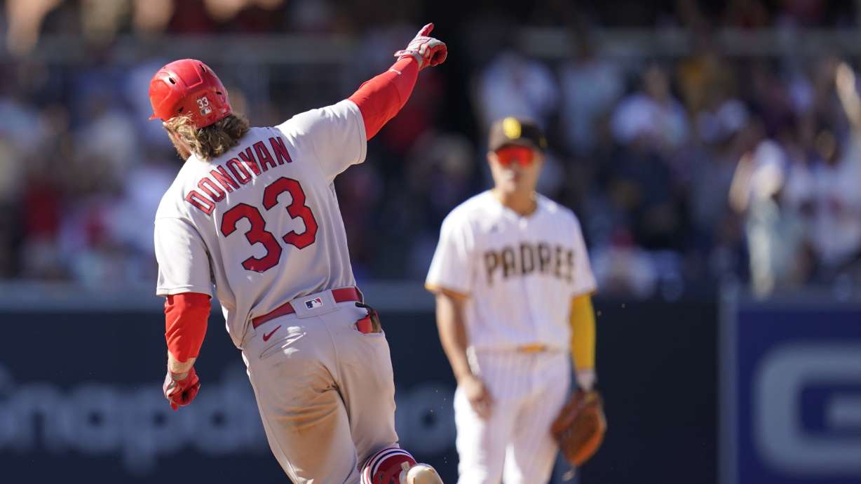 St. Louis Cardinals' Brendan Donovan, left, reacts after hitting a grand slam during the seventh inning of a baseball game against the San Diego Padres, Thursday, Sept. 22, 2022, in San Diego.