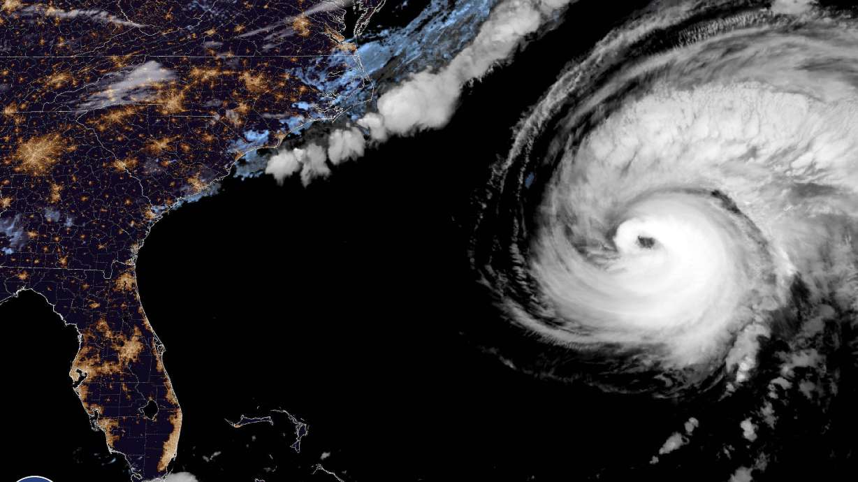 This image provided by the National Hurricane Center National Oceanic and Atmospheric Administration shows a satellite view as Hurricane Fiona moves up the United States Atlantic coast, Thursday night. Hurricane Fiona pounded Bermuda with heavy rains and winds as it swept by the island and is forecast to approach northeastern Canada as a still-powerful storm late Friday.