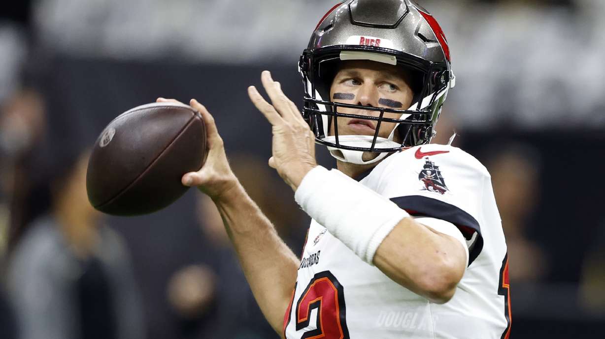 FILE - Tampa Bay Buccaneers quarterback Tom Brady warms up before the first half of an NFL football game against New Orleans Saints in New Orleans, Sunday, Sept. 18, 2022. In some Tampa Bay area schools, students use foam rollers and vibrating spheres to massage their muscles as they work toward goals for strength and flexibility. It's all part of a new physical education curriculum from Brady, whose vision for healthy living is fueling a fitness empire.