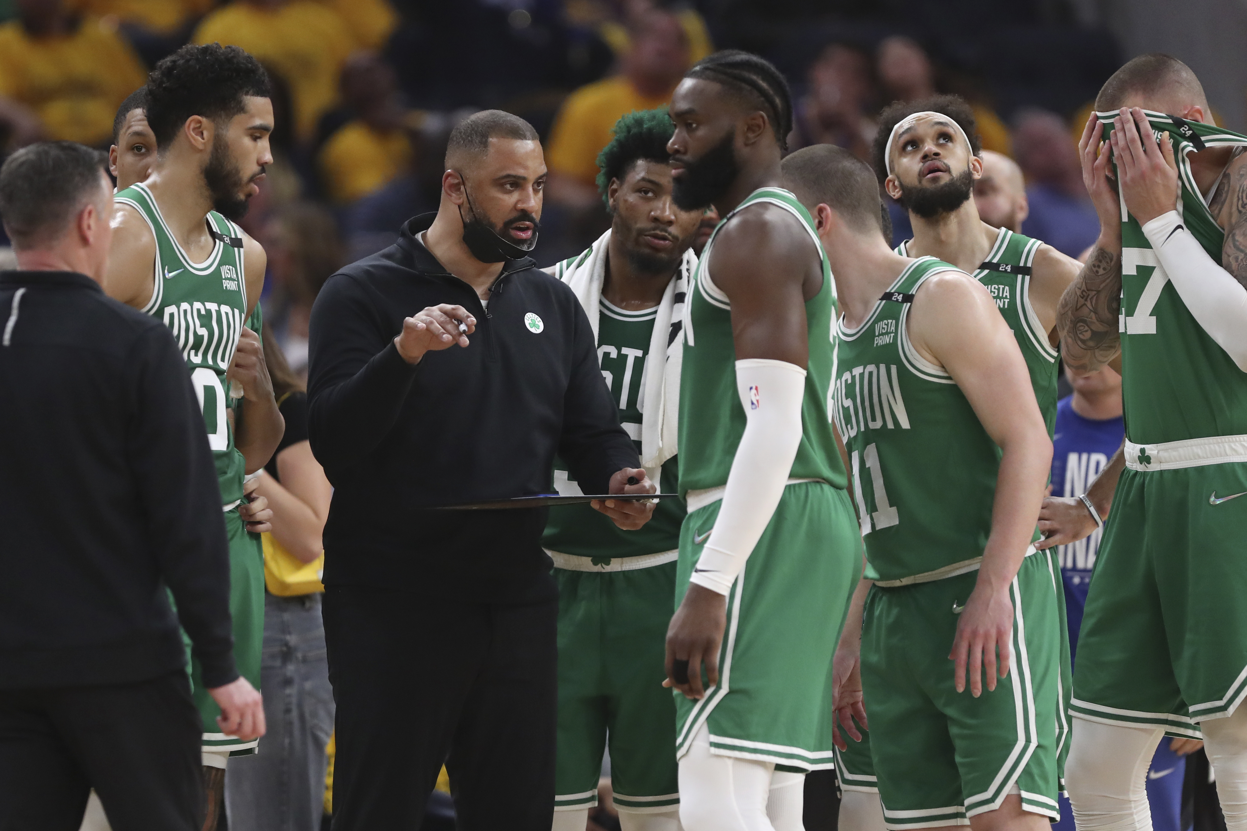FILE - Boston Celtics head coach Ime Udoka, center left, talks with players during the first half of Game 2 of basketball's NBA Finals against the Golden State Warriors in San Francisco, Sunday, June 5, 2022. The Boston Celtics are planning to discipline coach Ime Udoka, likely with a suspension, because of an improper relationship with a member of the organization, two people with knowledge of the matter told The Associated Press on Thursday, Sept. 22, 2022. 