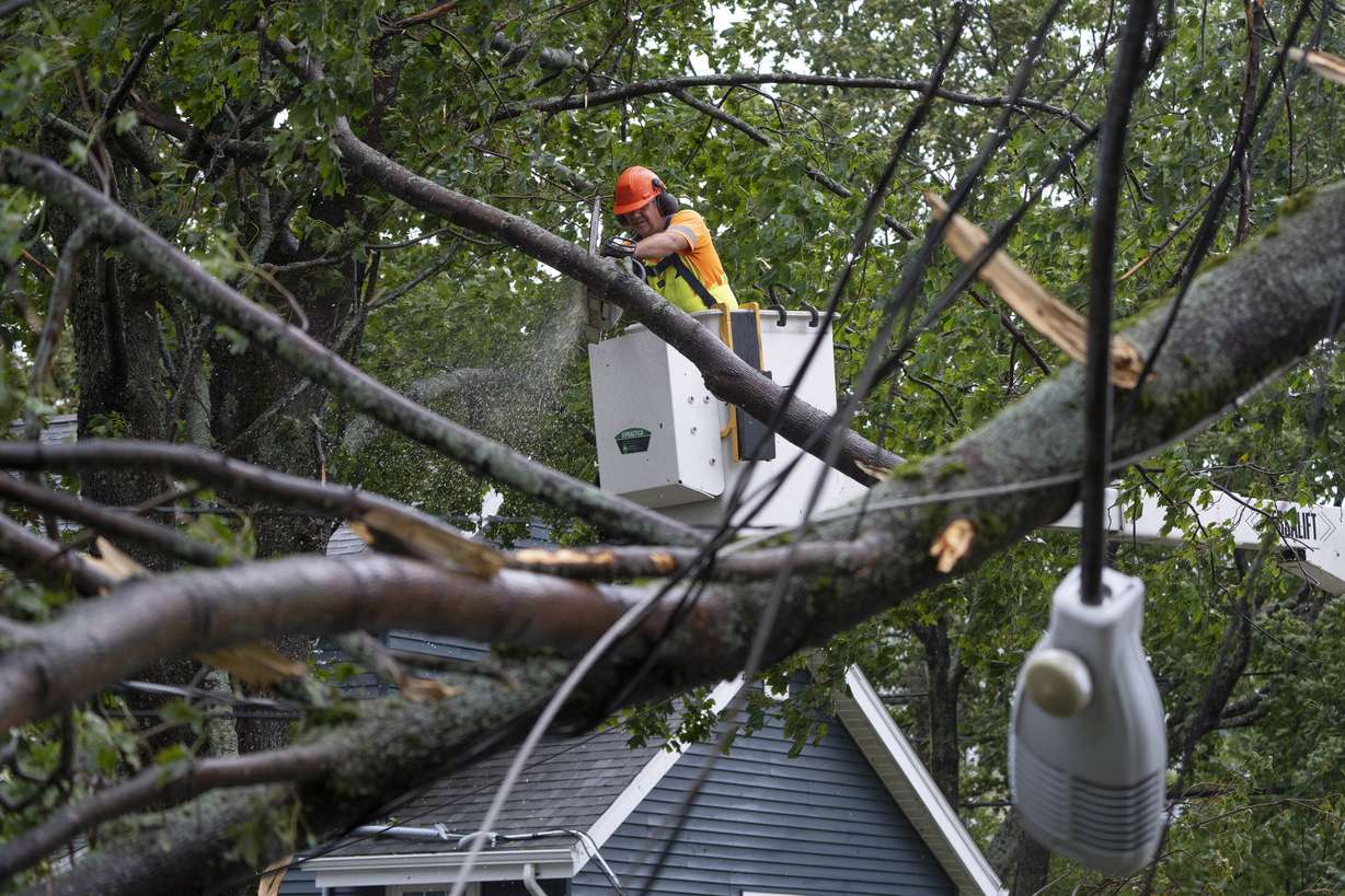 A worker clears fallen trees and downed wires from damage caused by post-tropical storm Fiona in Halifax on Saturday. Strong rains and winds lashed the Atlantic Canada region as Fiona closed in early Saturday as a big, powerful post-tropical cyclone, and Canadian forecasters warned it could be one of the most severe storms in the country's history.
