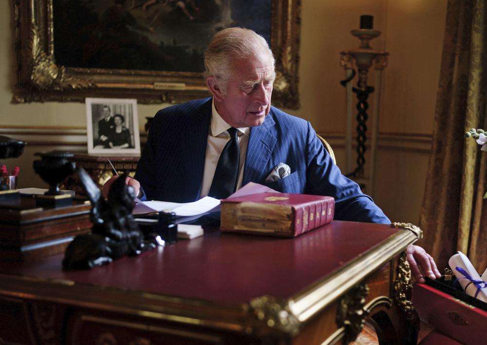 In this Sept. 11 photo, Britain's King Charles III carries out official government duties from his red box in the Eighteenth Century Room at Buckingham Palace, London.