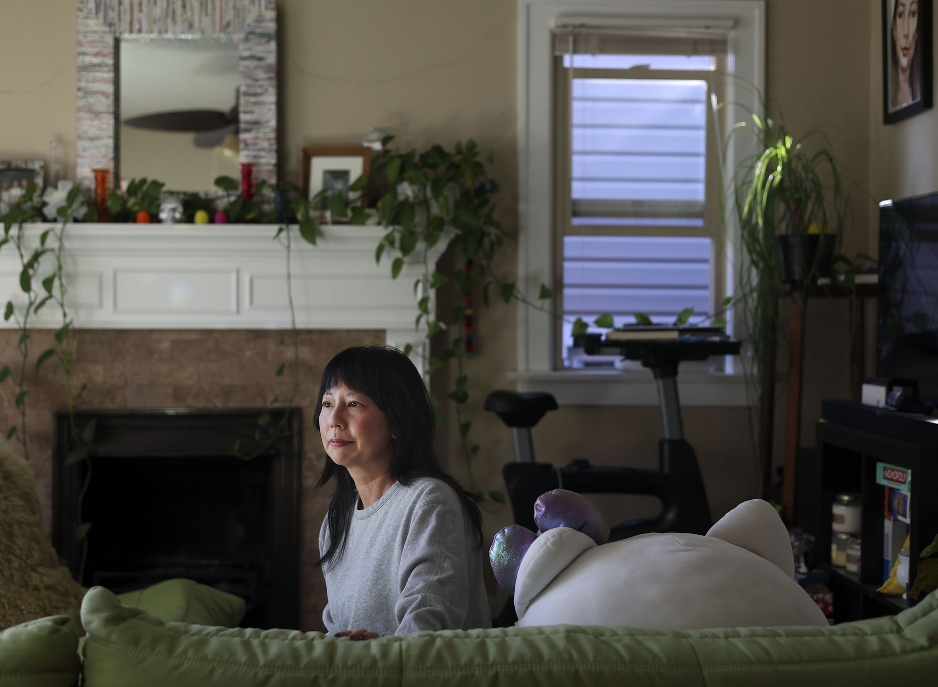 Jennifer Fei is pictured in her Sugar House rental on Friday. Fei has seen her rent price spike roughly $550 a month in the last two years. Fei has felt the pinch every year. But over the past couple of years, especially, the rental market's stranglehold on her household budget has been tightening.