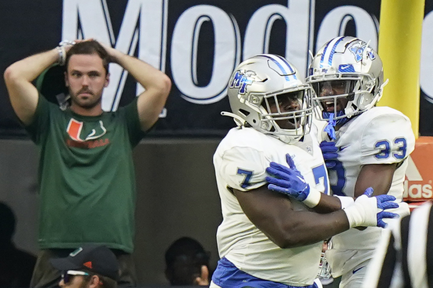 Middle Tennessee defensive tackle Zaylin Wood (7) celebrates with cornerback Decorian Patterson (33) after Wood intercepted the ball and scored during the first half of an NCAA college football game against Miami, Saturday, Sept. 24, 2022, in Miami Gardens, Fla. 