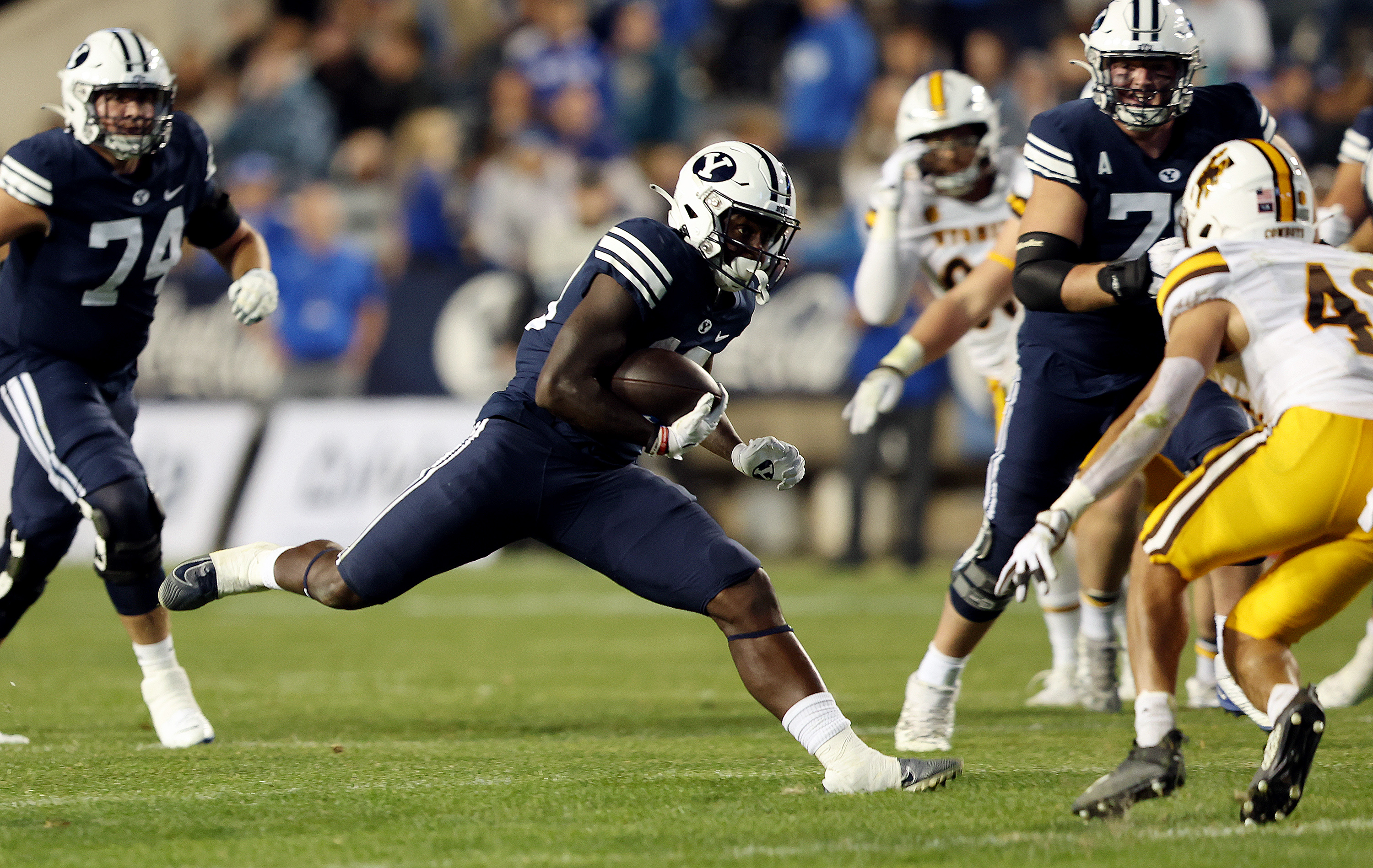 Brigham Young running back Miles Davis (19) makes a move during a run as BYU and Wyoming play at LaVell Edwards Stadium in Provo on Saturday, Sept. 24, 2022. BYU won 38-24.