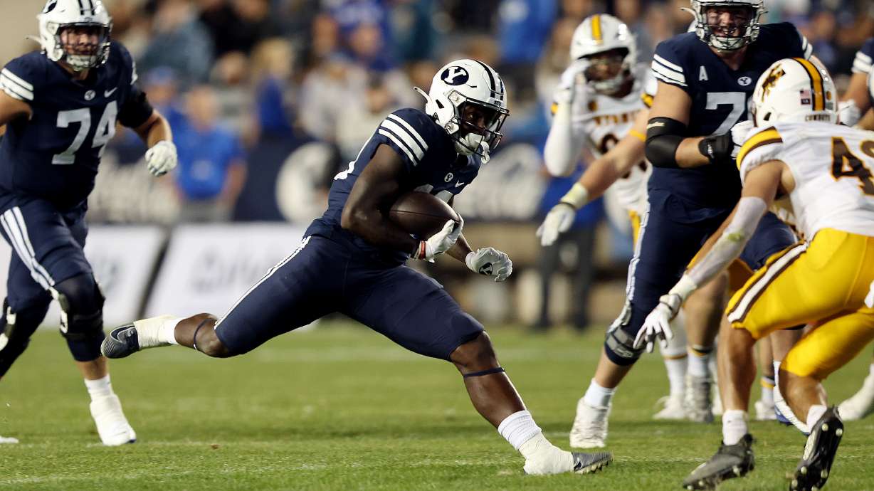 Brigham Young Cougars running back Miles Davis (19) makes a move during a run as BYU and Wyoming play at LaVell Edwards Stadium in Provo on Saturday, Sept. 24, 2022. BYU won 38-24.