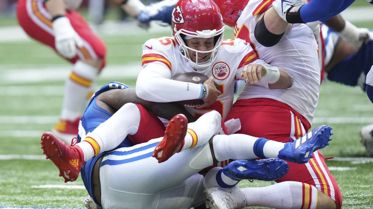 Kansas City Chiefs quarterback Patrick Mahomes (15) is sacked by Indianapolis Colts defensive end Yannick Ngakoue (91) during the first half of an NFL football game, Sunday, Sept. 25, 2022, in Indianapolis.