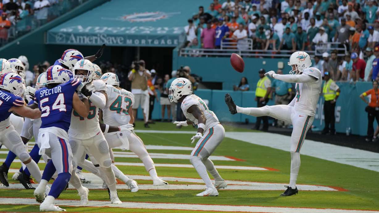 Miami Dolphins punter Thomas Morstead (4) sees the ball go backwards after attempting a punt during the second half of an NFL football game against the Buffalo Bills, Sunday, Sept. 25, 2022, in Miami Gardens, Fla. The play resulted in a safety for the Buffalo Bills.
