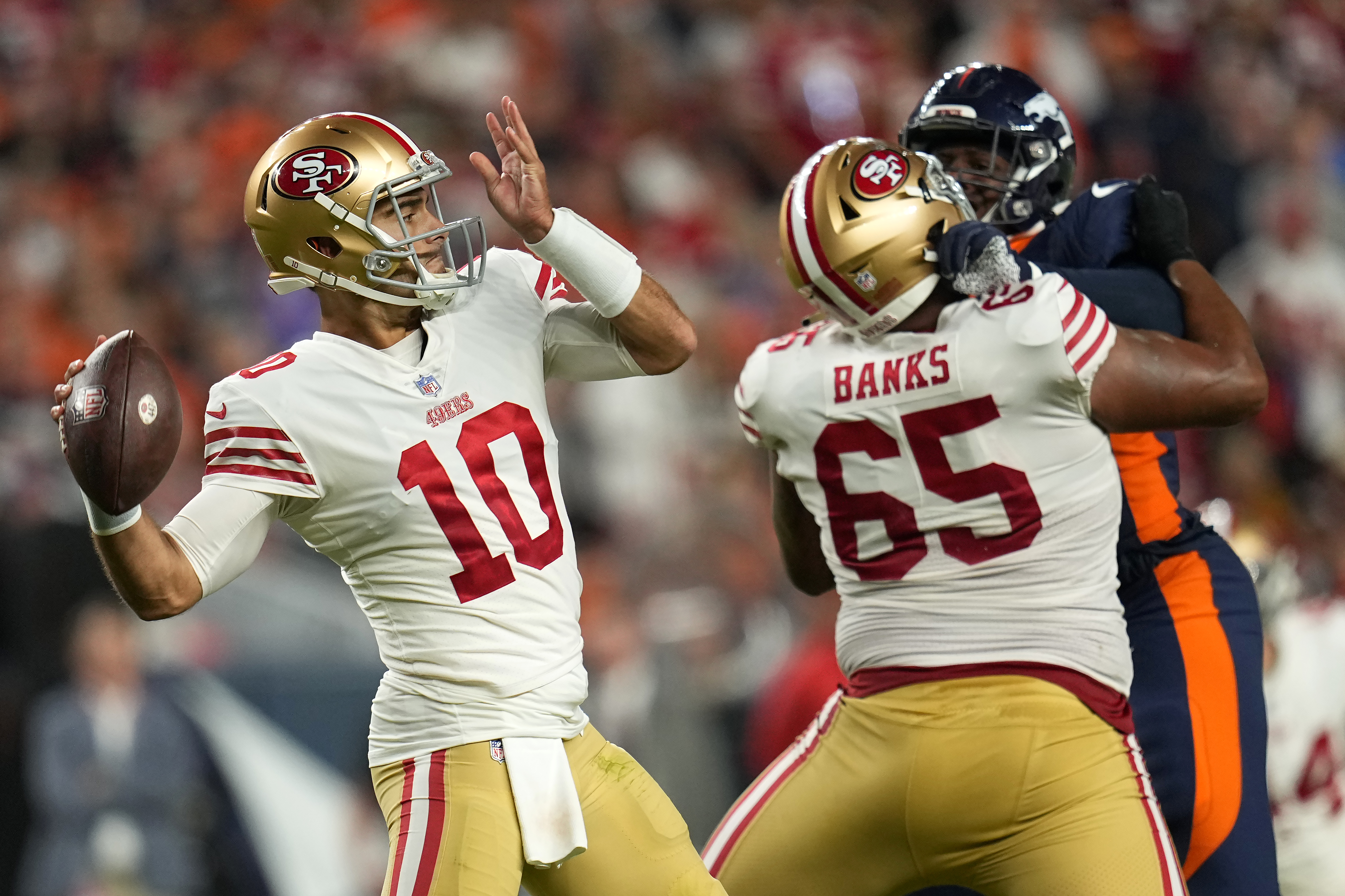 San Francisco 49ers quarterback Jimmy Garoppolo (10) passes against the Denver Broncos during the first half of an NFL football game in Denver, Sunday, Sept. 25, 2022.