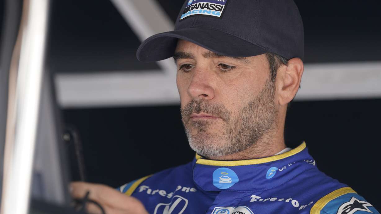 FILE - Jimmie Johnson sits in his pit box before the final practice for the Indianapolis 500 auto race at Indianapolis Motor Speedway, Friday, May 27, 2022, in Indianapolis. Jimmie Johnson announced Friday, Sept. 9, 2022, that sponsor Carvana has agreed to fund next year's racing endeavors and the seven-time NASCAR champion will use the next few weeks to determine his 2023 schedule.