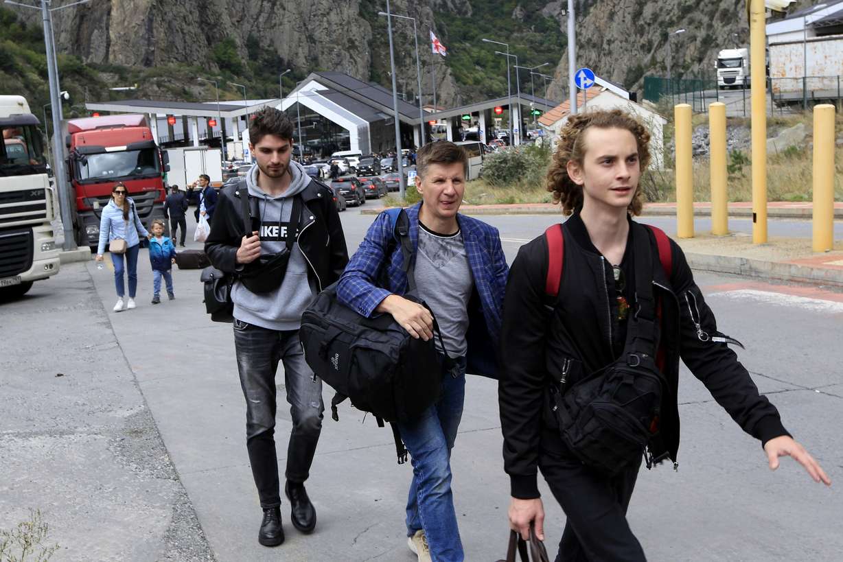 A group of young Russians walk along the border crossing Verkhny Lars between Georgia and Russia on Friday.