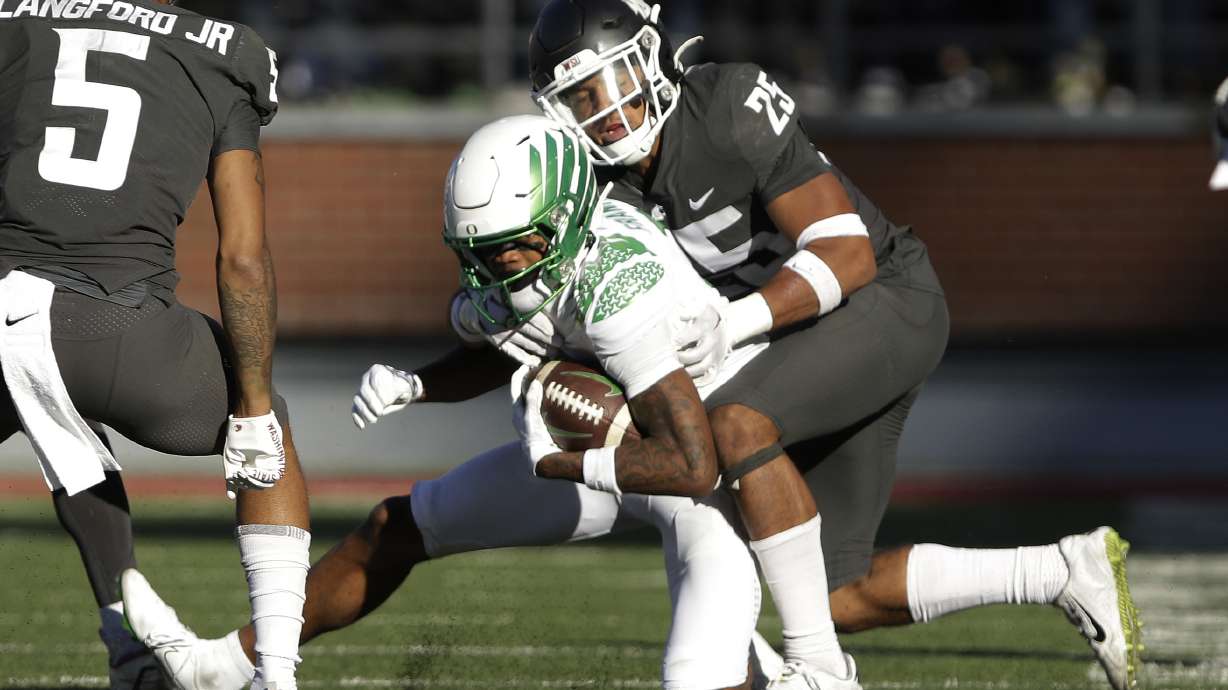 Washington State defensive back Jaden Hicks, right, tackles Oregon wide receiver Troy Franklin during the second half of an NCAA college football game, Saturday, Sept. 24, 2022, in Pullman, Wash.