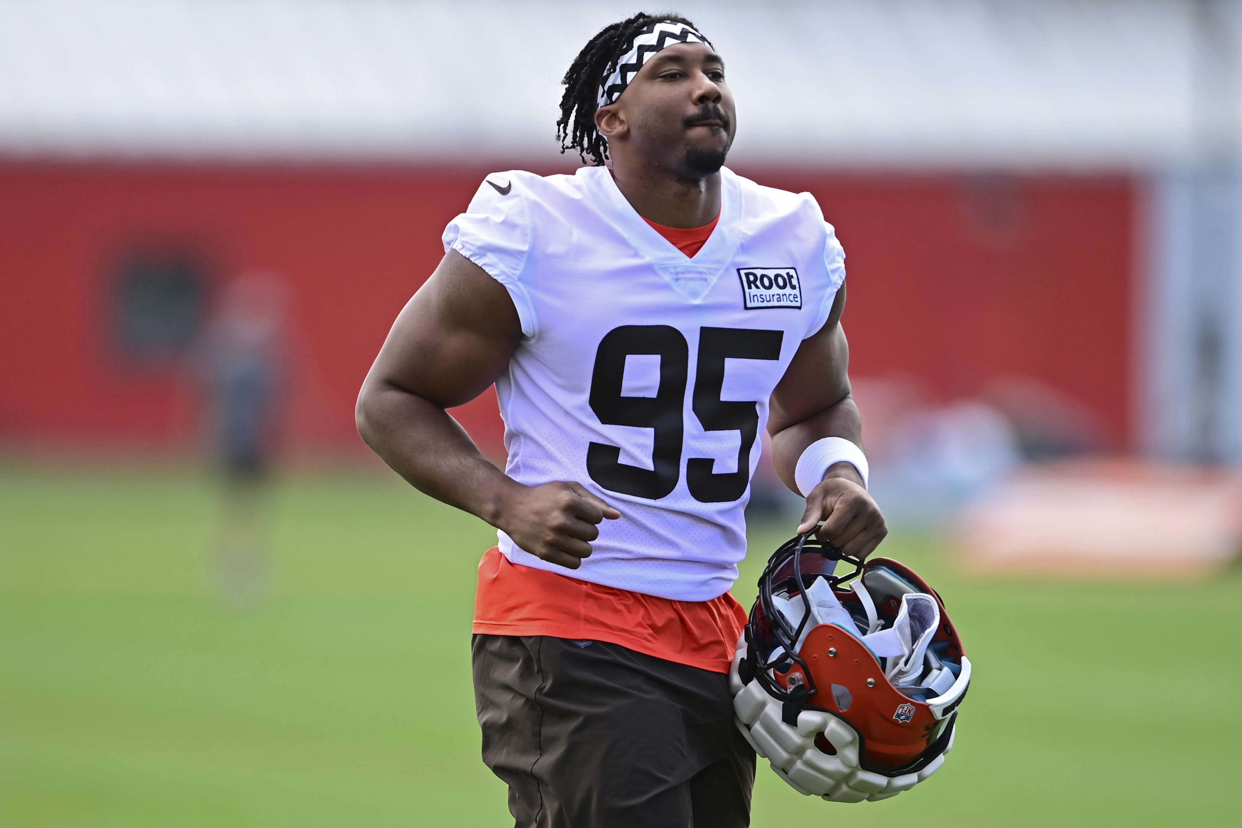 FILE - Cleveland Browns defensive end Myles Garrett runs during an NFL football practice in Berea, Ohio, Friday, July 29, 2022. Garrett has 58 1/2 sacks in five seasons with the Browns and four straight double-digit sacks seasons, including a career-high 16 last year. The Browns play the Carolina Panthers on Sunday. 