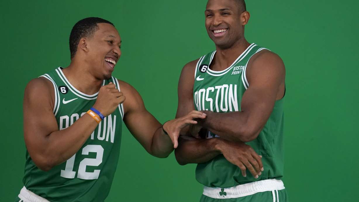 Boston Celtics forward Grant Williams, left, jokes with center Al Horford, right, as the NBA basketball players stand for photos during the team's Media Day, Monday, Sept. 26, 2022, in Canton, Mass.