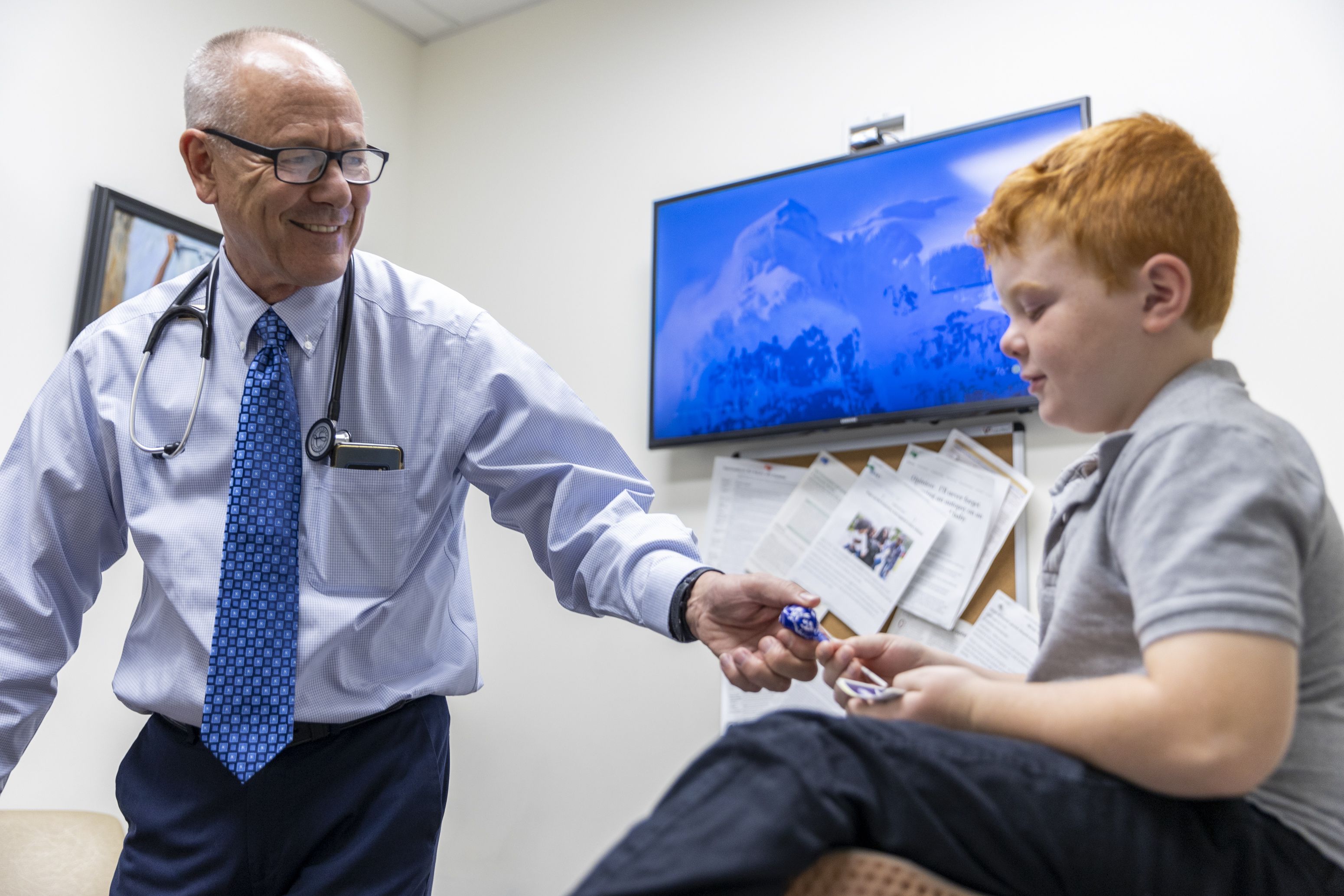 Dr. David Cope hands Kason Deslaurier, 8, a lollipop after an appointment at Cope Family Medicine in Bountiful on Monday. Vaccine exemptions for Utah kindergartners were up last school year.