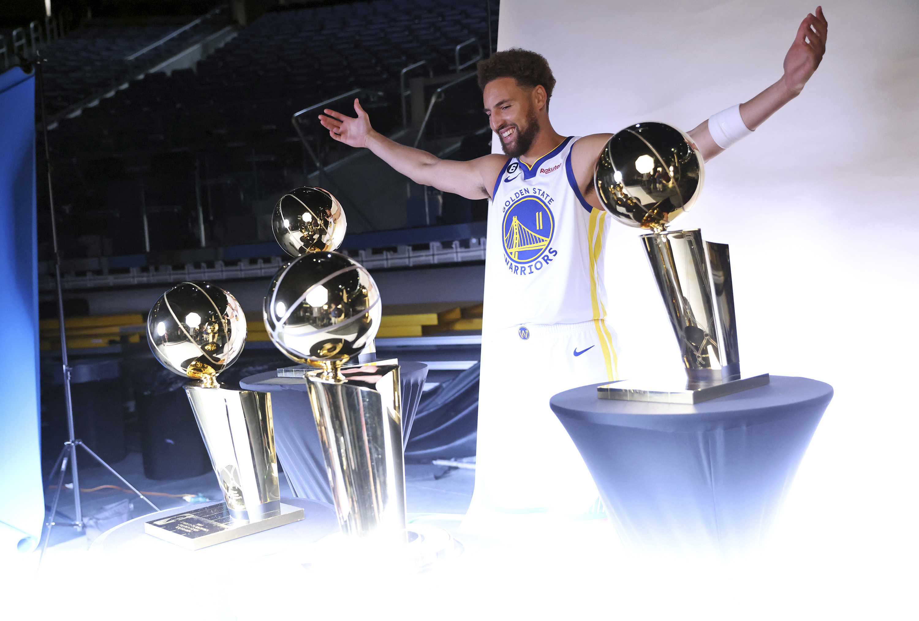 Golden State Warriors' Klay Thompson poses with four Larry O'Brien trophies during Media Day at Chase Center in San Francisco, Sunday, Sept. 25, 2022. 