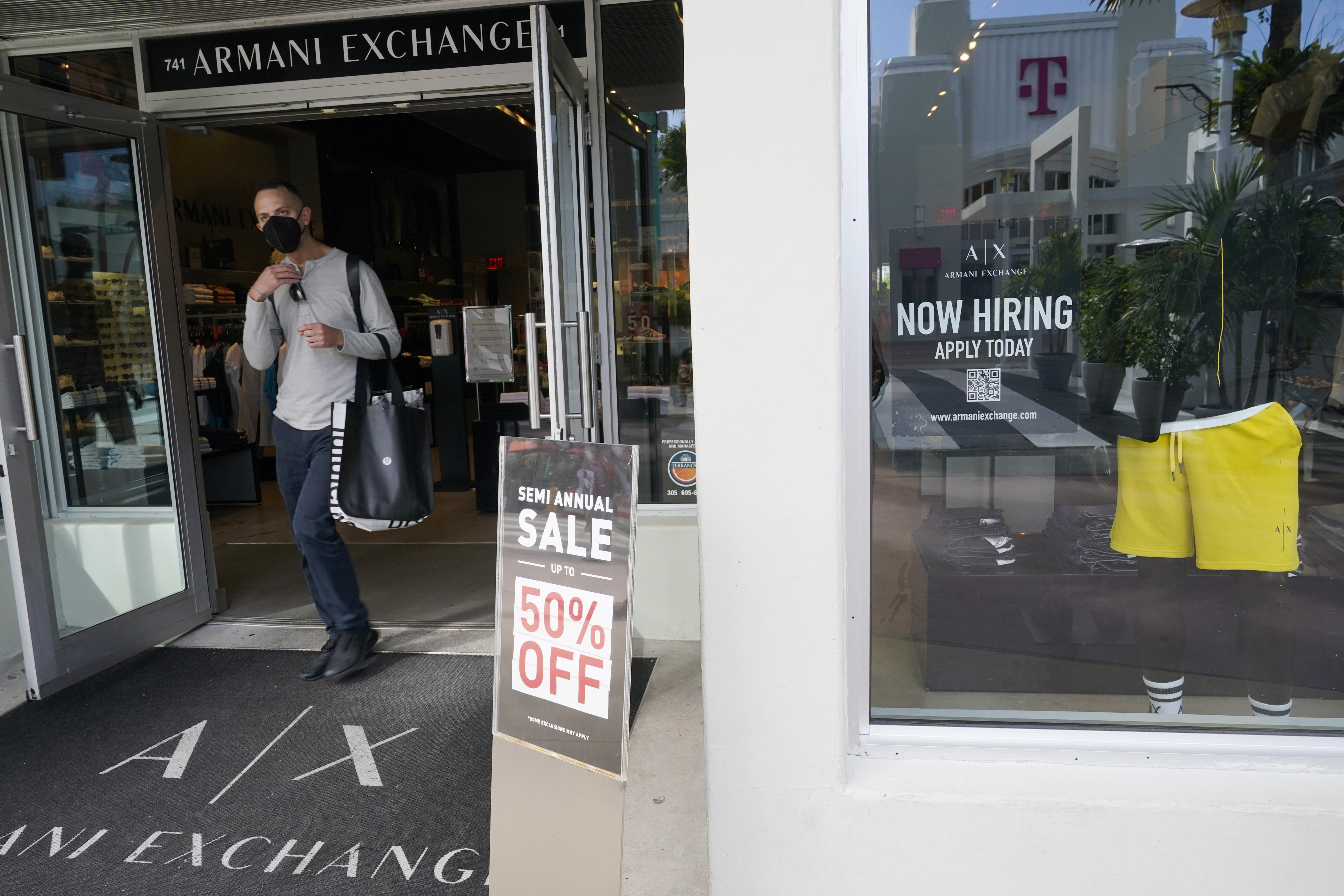 A shopper walks out of an Armani Exchange store, Jan. 21 in Miami Beach, Fla. The Conference Board said Tuesday that its consumer confidence index rose to 108 in September, from 103.6 in August.