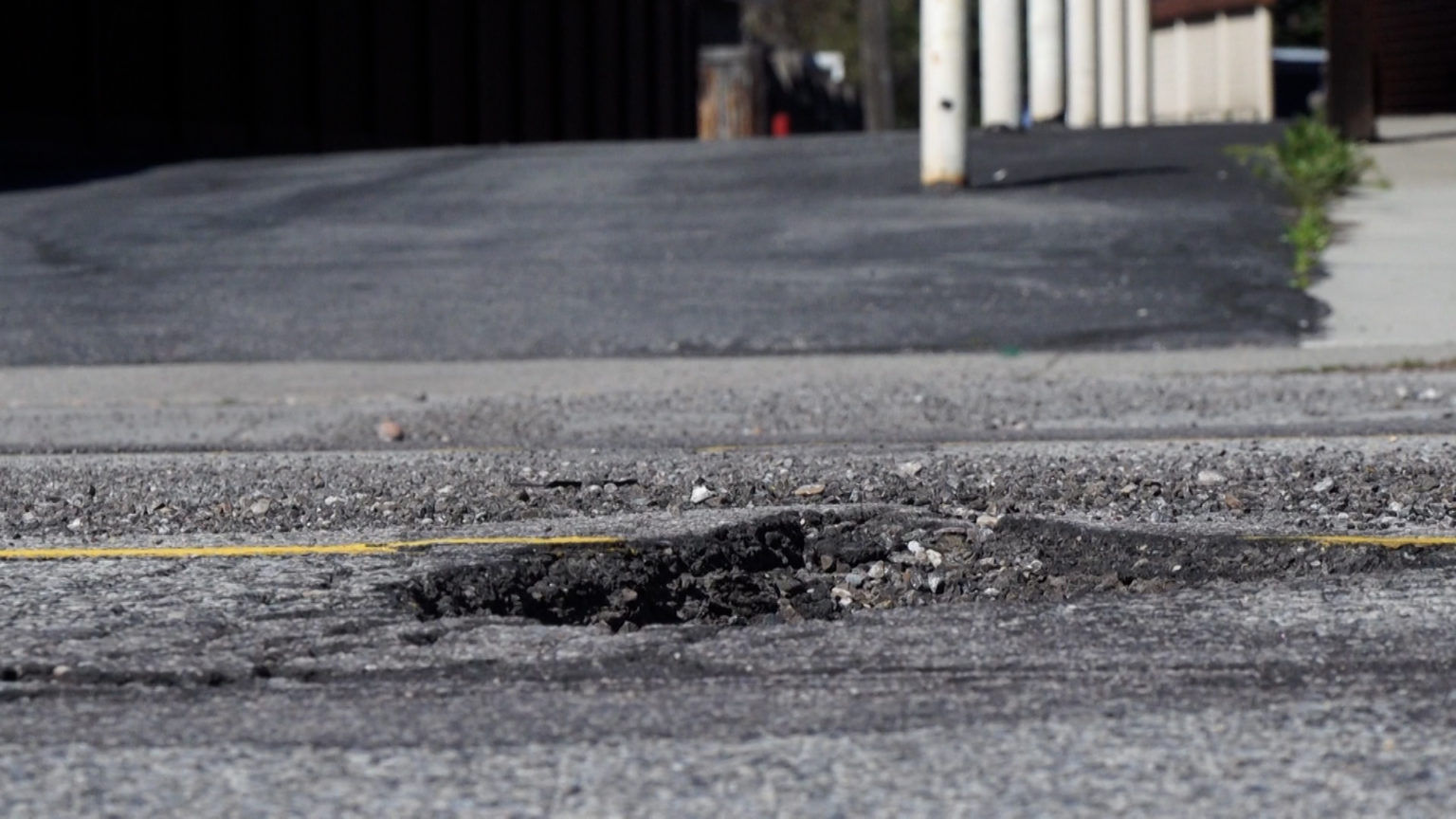 A pothole is shown in a Utah road. Local governments aren’t automatically immune from paying for pothole damage, but claimants have to prove the government knew about the pothole beforehand and failed to fix it.