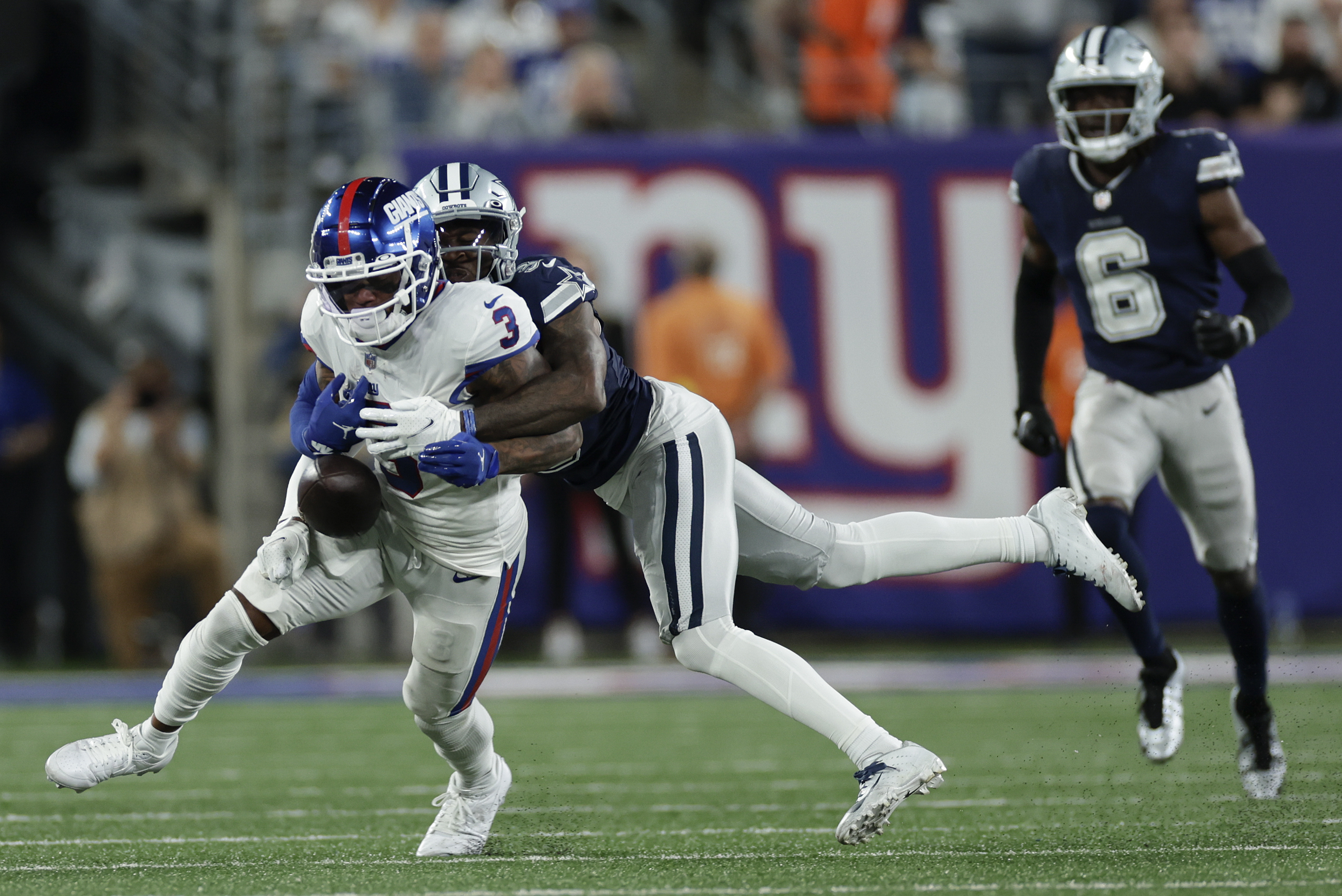 Dallas Cowboys cornerback Anthony Brown (3) strips the ball from New York Giants wide receiver Sterling Shepard (3) during the fourth quarter of an NFL football game, Monday, Sept. 26, 2022, in East Rutherford, N.J. 