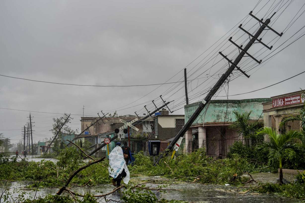 Fallen utility poles and fallen branches line a street after Hurricane Ian hit Pinar del Rio, Cuba, Tuesday.