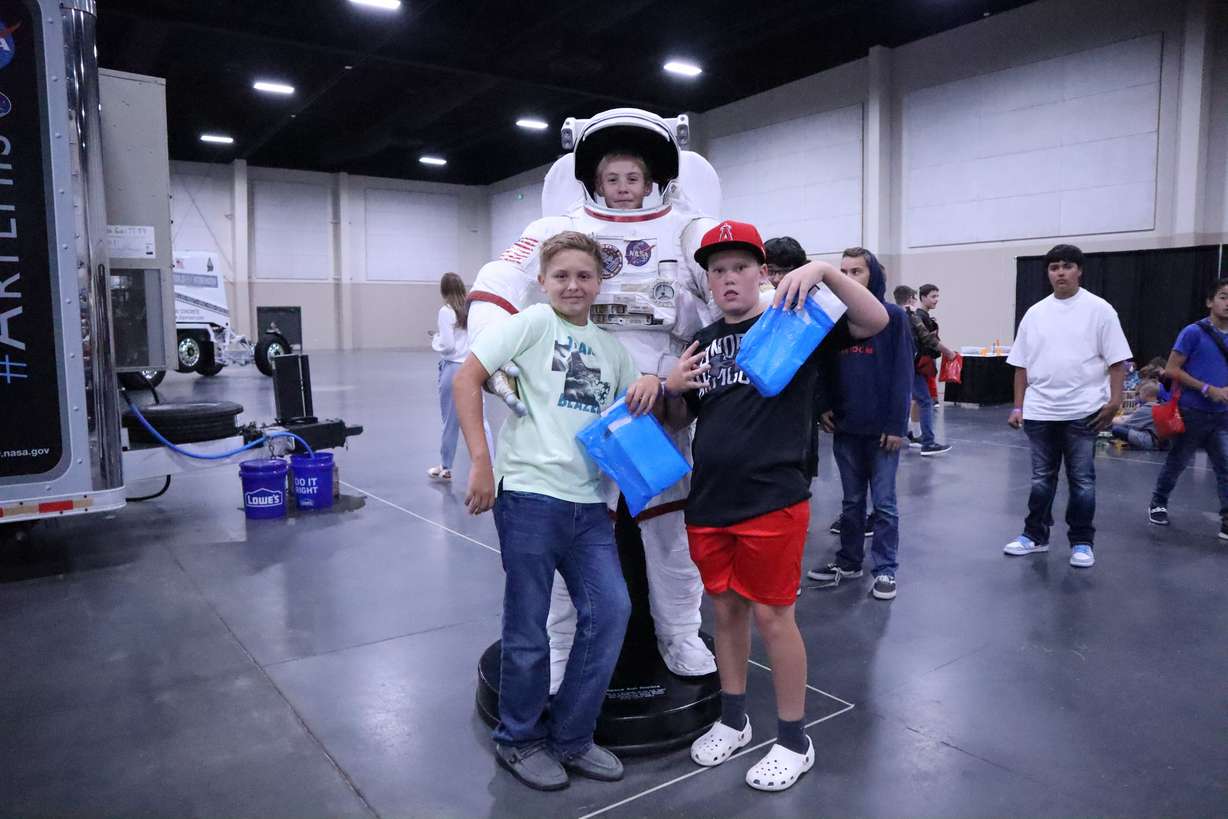 Canyon View Middle School students Easton Grange, Jayden Eley, and Grady Oveson
pose for a picture with a NASA space suit at STEM Fest at the Mountain America Credit Union in Sandy on Tuesday.