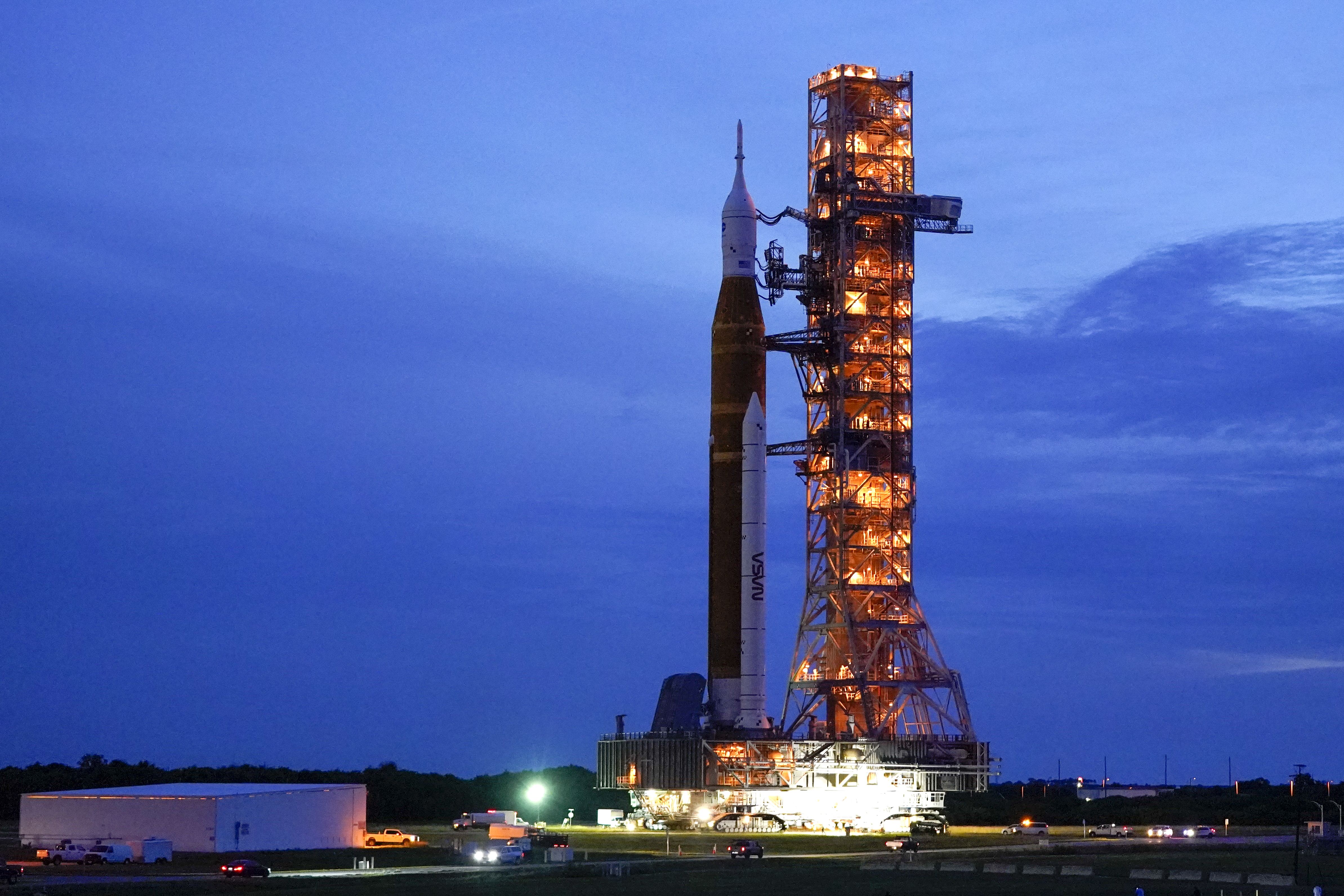 The NASA moon rocket slated for the Artemis mission to the moon rolls back to the Vehicle Assembly Building at the Kennedy Space Center Tuesday in Cape Canaveral, Fla. The launch of the rocket was postponed due to the impending arrival of Hurricane Ian.