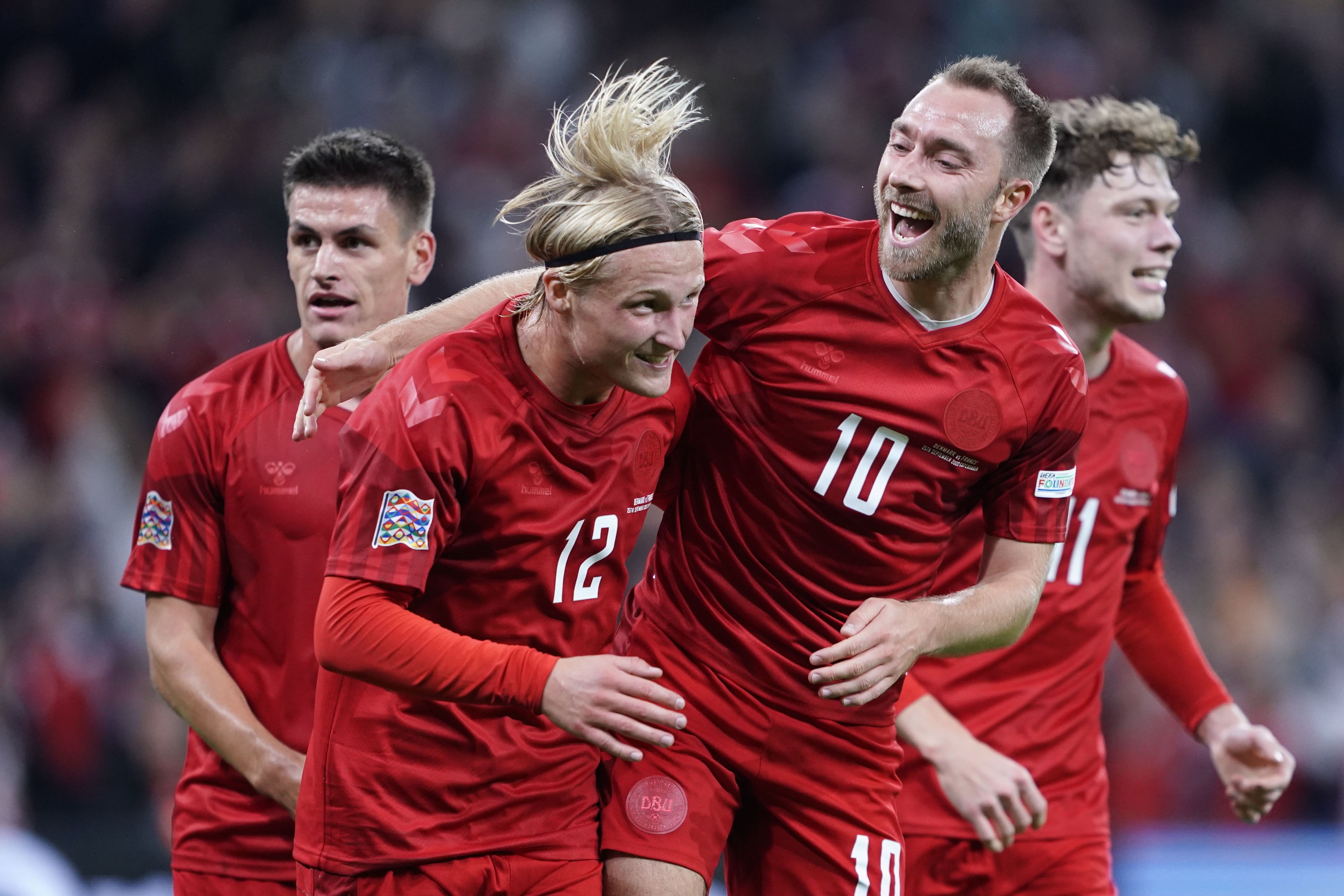 Denmark's Kasper Dolberg, second left, celebrates scoring with teammates Christian Eriksen, center right, Joachim Maehle and Andreas Skov Olsen, right, during the UEFA Nations League soccer match between Denmark and France at Parken Stadium in Copenhagen, Denmark, Sunday Sept. 25, 2022.
