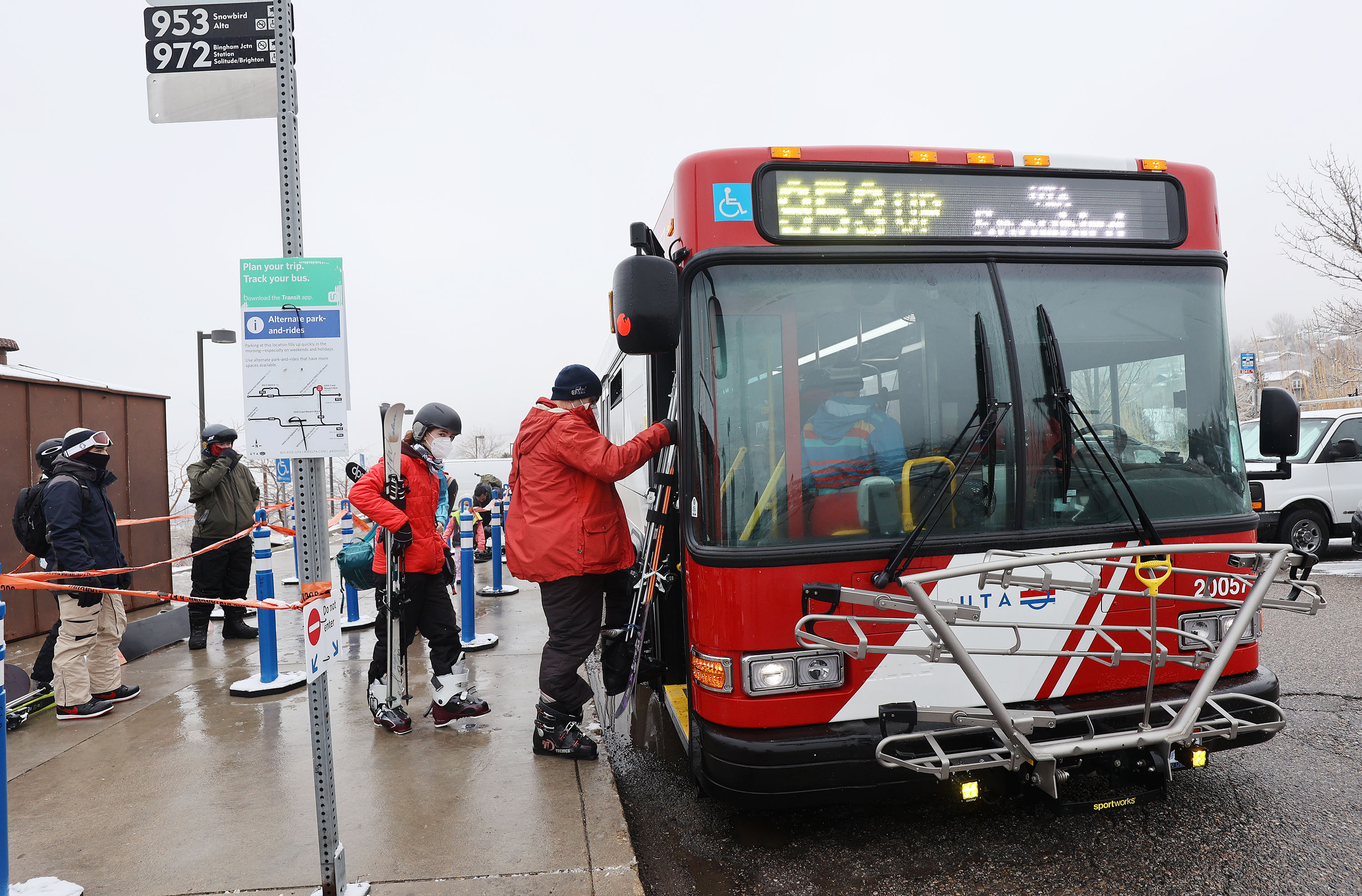 Skiers board a Utah Transit Authority bus Route 953 on Wasatch Boulevard in Cottonwood Heights on Jan. 24, 2021. The bus route is one of three that will be suspended in December, UTA announced Wednesday.