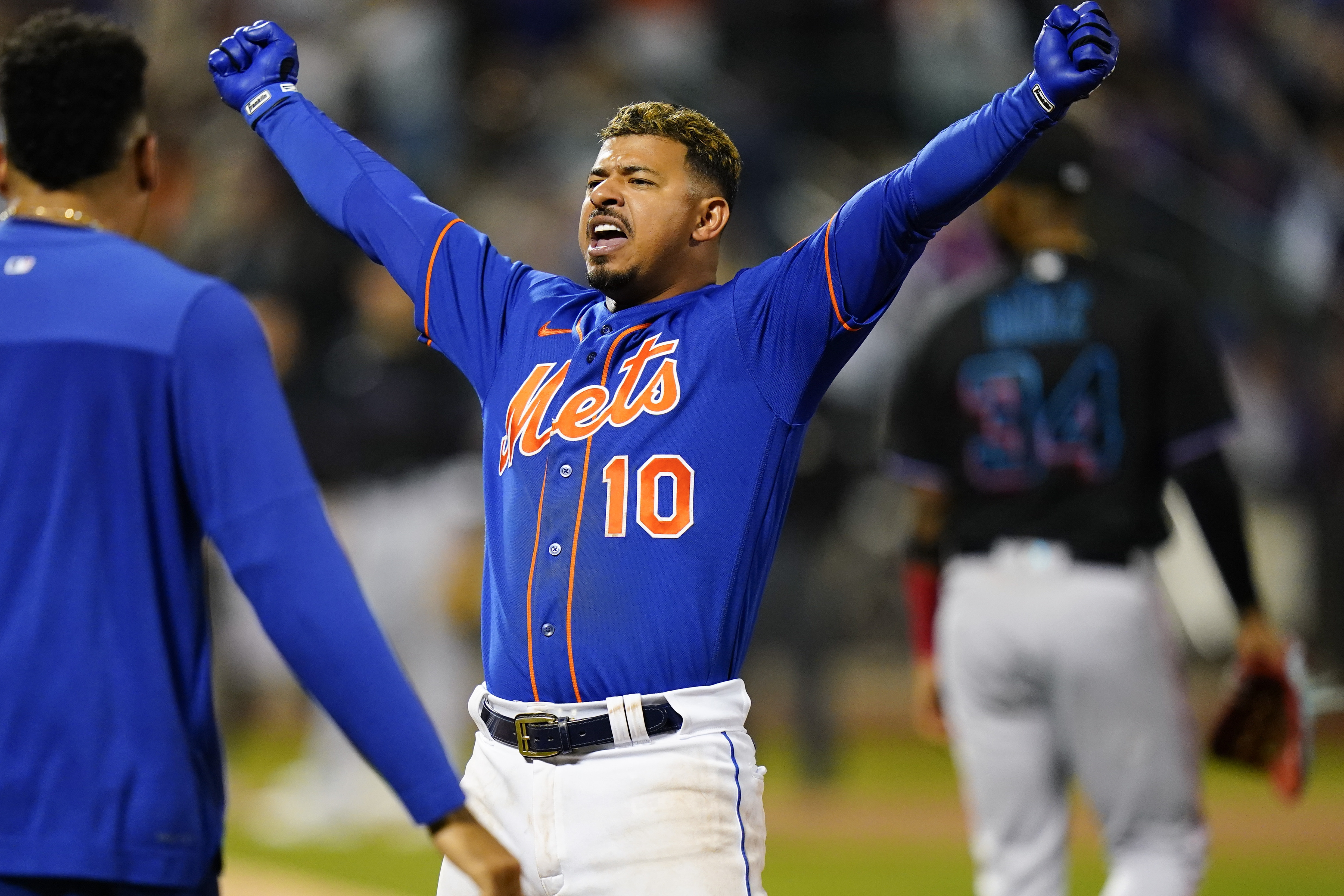 New York Mets' Eduardo Escobar (10) celebrates after hitting a walk-off RBI single during the 10th inning of a baseball game against the Miami Marlins Wednesday, Sept. 28, 2022, in New York. The Mets won 5-4. 