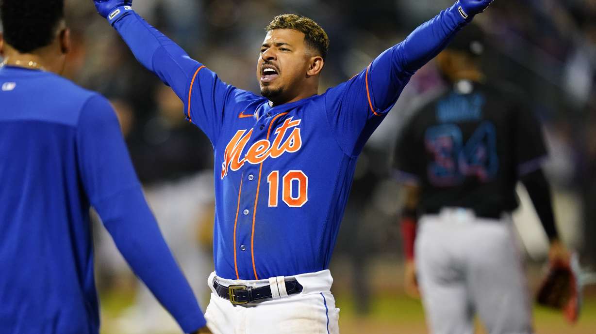 New York Mets' Eduardo Escobar (10) celebrates after hitting a walk-off RBI single during the 10th inning of a baseball game against the Miami Marlins Wednesday, Sept. 28, 2022, in New York. The Mets won 5-4.