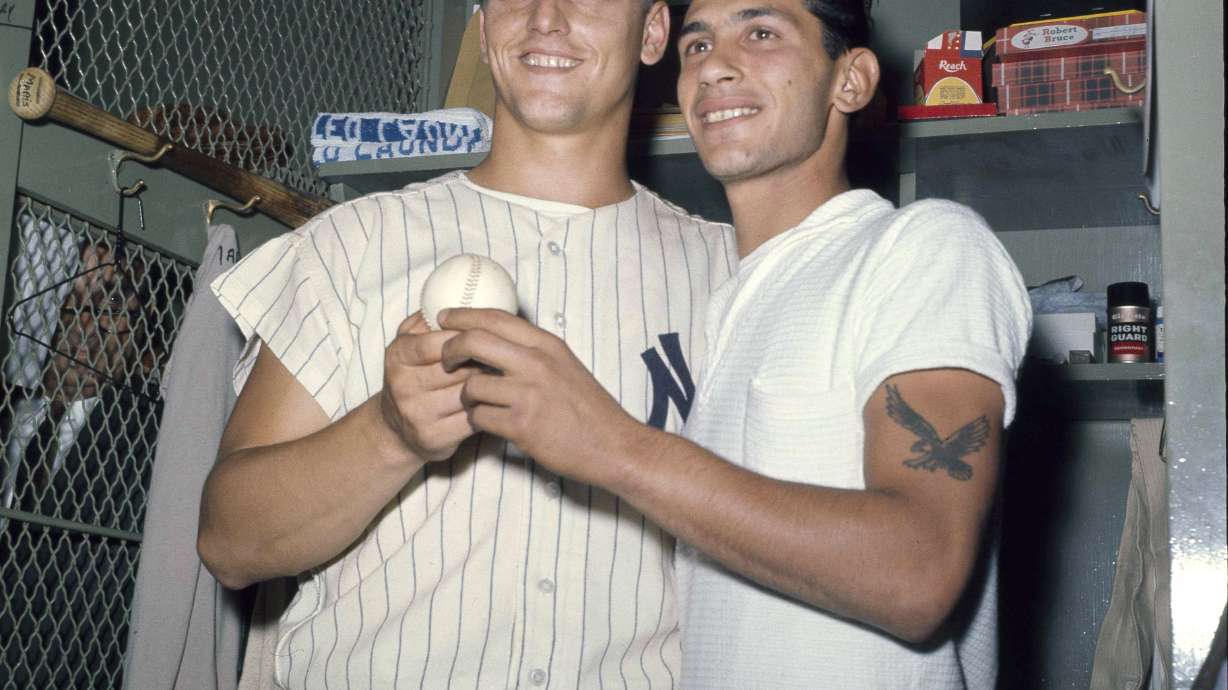 FILE - New York Yankees slugger Roger Maris poses with fan Sal Durante in the locker room at Yankee Stadium, Oct. 1, 1961, after hitting his 61st home run of the season. Durante caught Maris' fourth inning home run into the right field seats as Maris broke Babe Ruth's single-season home run record. If Aaron Judge passes Roger Maris, some lucky fan might become this generation's Sal Durante.