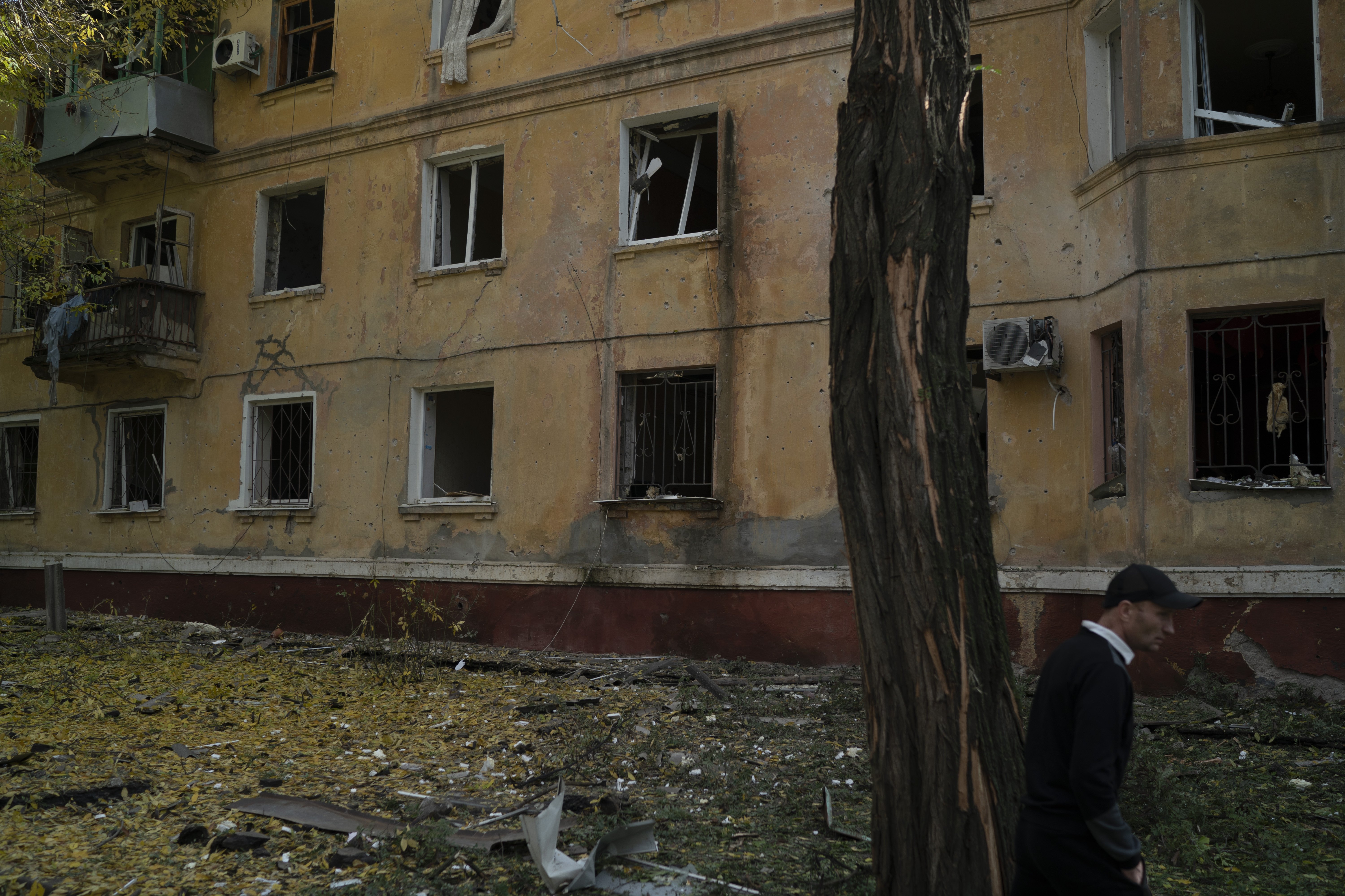 A man walks past a damaged building after a Russian attack in Kramatorsk, Ukraine, Thursday. Russia is planning to annex more of Ukraine on Friday. 