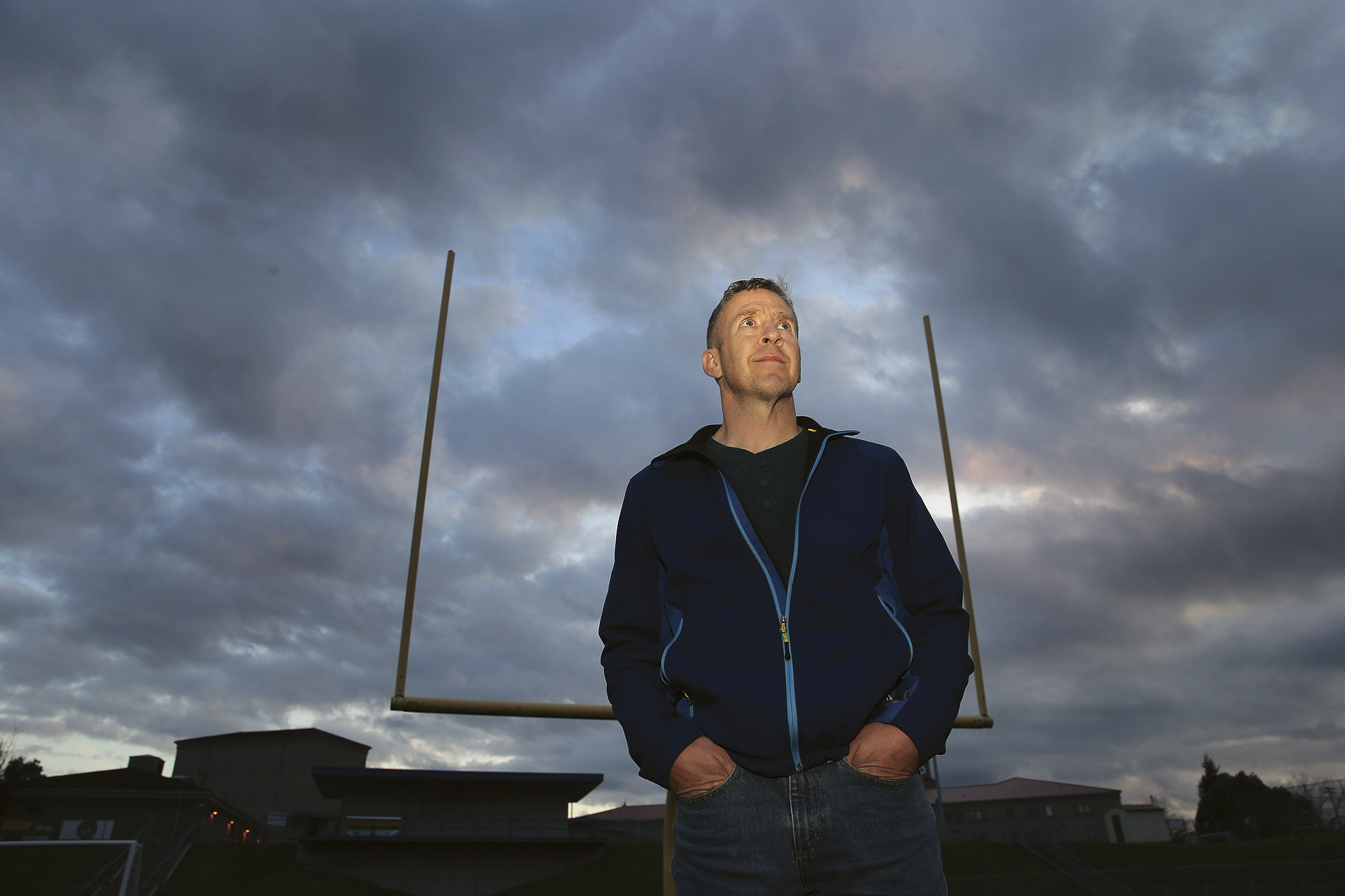 FILE - Former Bremerton High School assistant football coach Joe Kennedy stands on the field at Bremerton Memorial Stadium, Nov. 5, 2015. After the June 27, 2022 U.S. Supreme Court ruling in favor of the high school football coach’s right to pray on the field after games, there were predictions of sweeping consequences from across the ideological spectrum. But three months after the decision, there’s no sign that large numbers of coaches are following Kennedy’s high-profile example. 