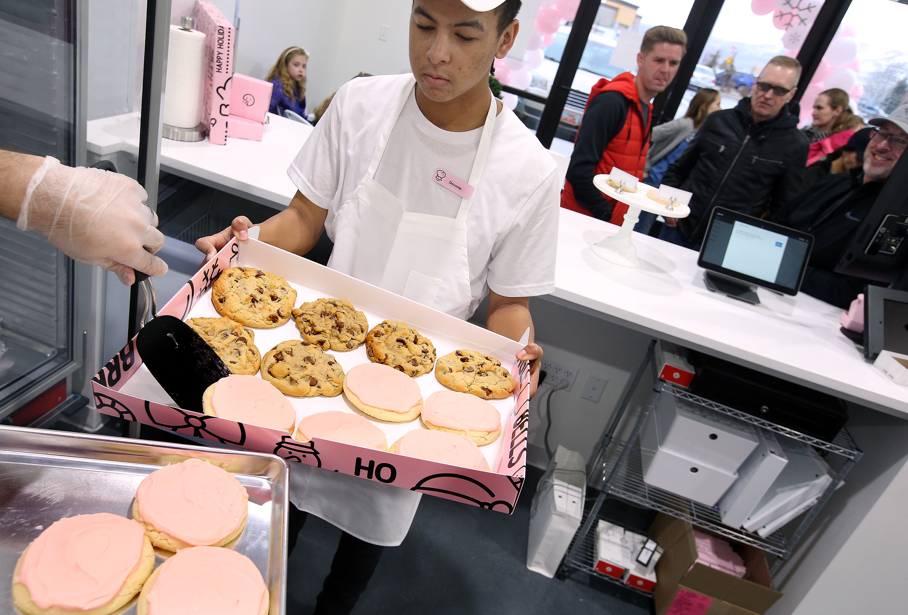 Deyonte Dennis prepares a party box of cookies for a customer at Crumbl in Lehi on Dec. 21, 2018. Crumbl's lawsuit against rival Dirty Dough is nearing an end after a notice of settlement was filed Friday. 