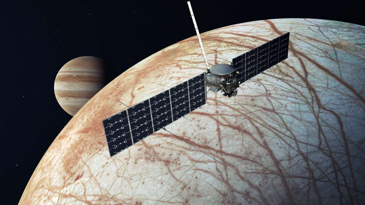 This illustration shows the future Europa Clipper mission after its arrival at the icy moon, with Jupiter in the background.