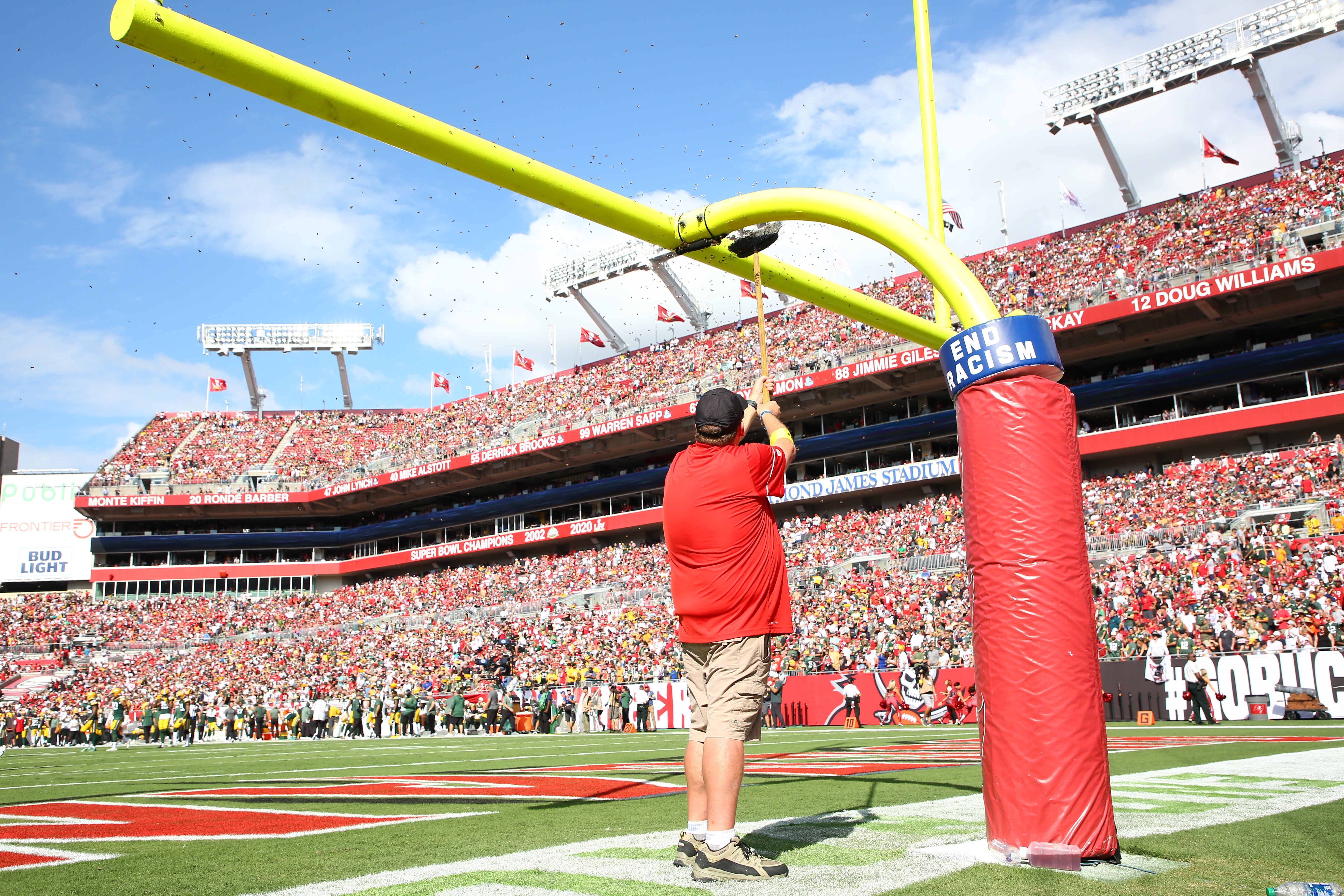 Honey bees are swept from an upright at the beginning of the NFL football game between the Tampa Bay Buccaneers and the Green Bay Packers on Sunday, Sept. 25, 2022, at Raymond James Stadium in Tampa, Fla. 