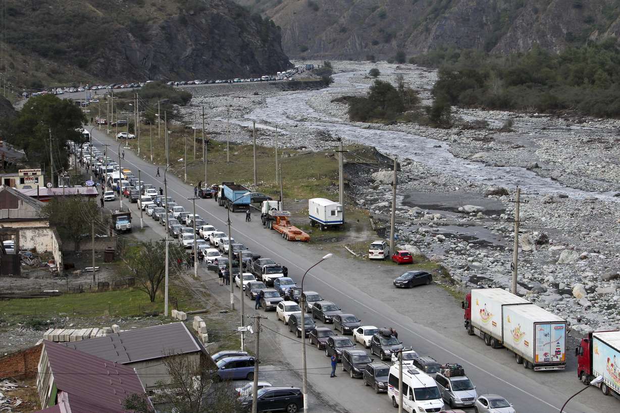 Cars queuing toward the border crossing at Verkhny Lars between Russia and Georgia, leaving Chmi, North Ossetia - Alania Republic, in Russia, Thursday.