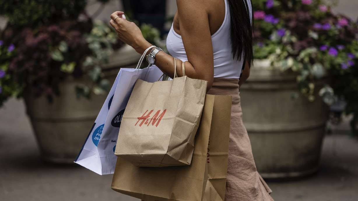 A shopper carries an H&M bag in New York, on July 28. The fast-fashion seller said it is gearing up to test return fees on merchandise in some markets.