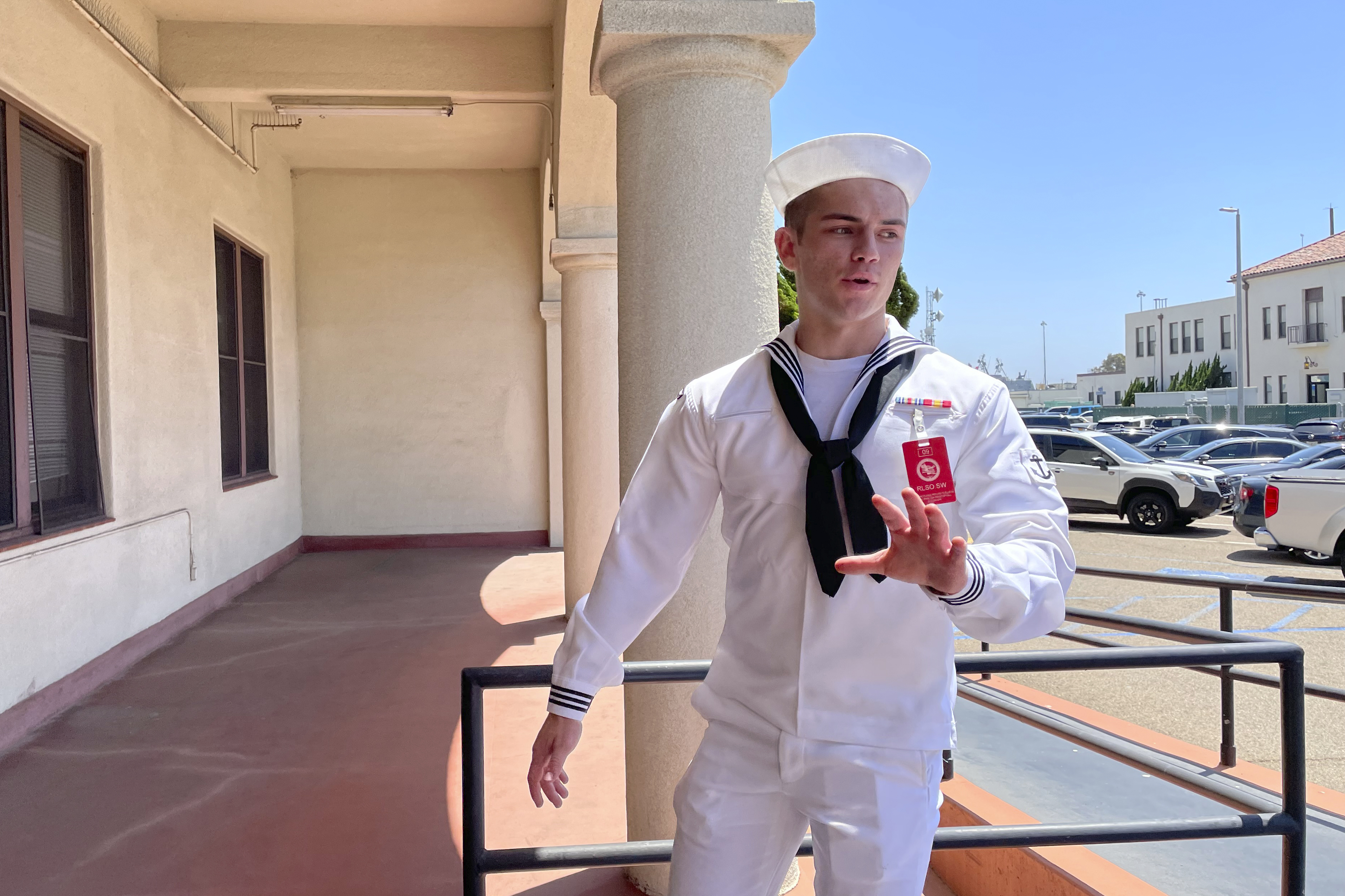 U.S. Navy sailor Ryan Sawyer Mays walks past reporters at Naval Base San Diego before entering a Navy courtroom on Aug. 17, in San Diego. Mays is accused of setting the USS Bonhomme Richard on fire.