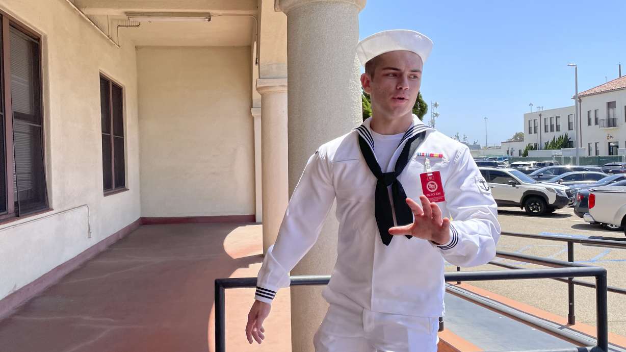 U.S. Navy sailor Ryan Sawyer Mays walks past reporters at Naval Base San Diego before entering a Navy courtroom on Aug. 17, in San Diego. Mays is accused of setting the USS Bonhomme Richard on fire.